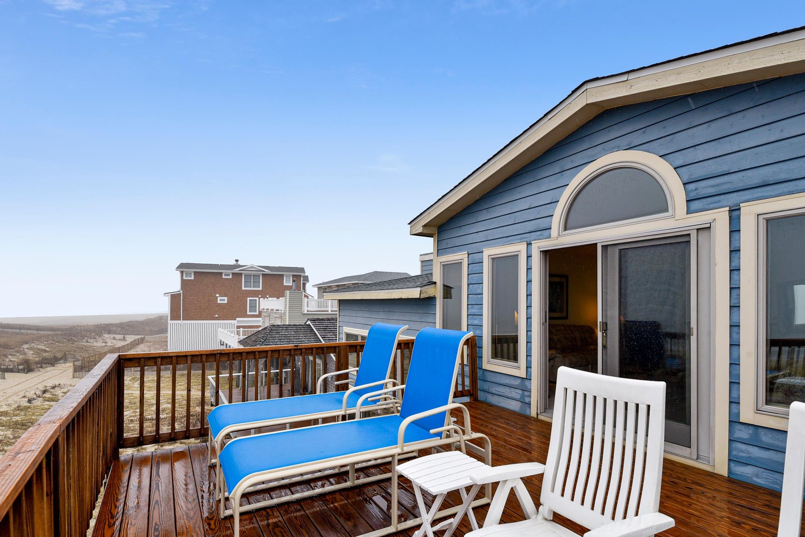A sun-drenched deck awaits you with lounge chairs for soaking up ocean breezes and distant dune views, perfect for your morning coffee or sunset relaxation.