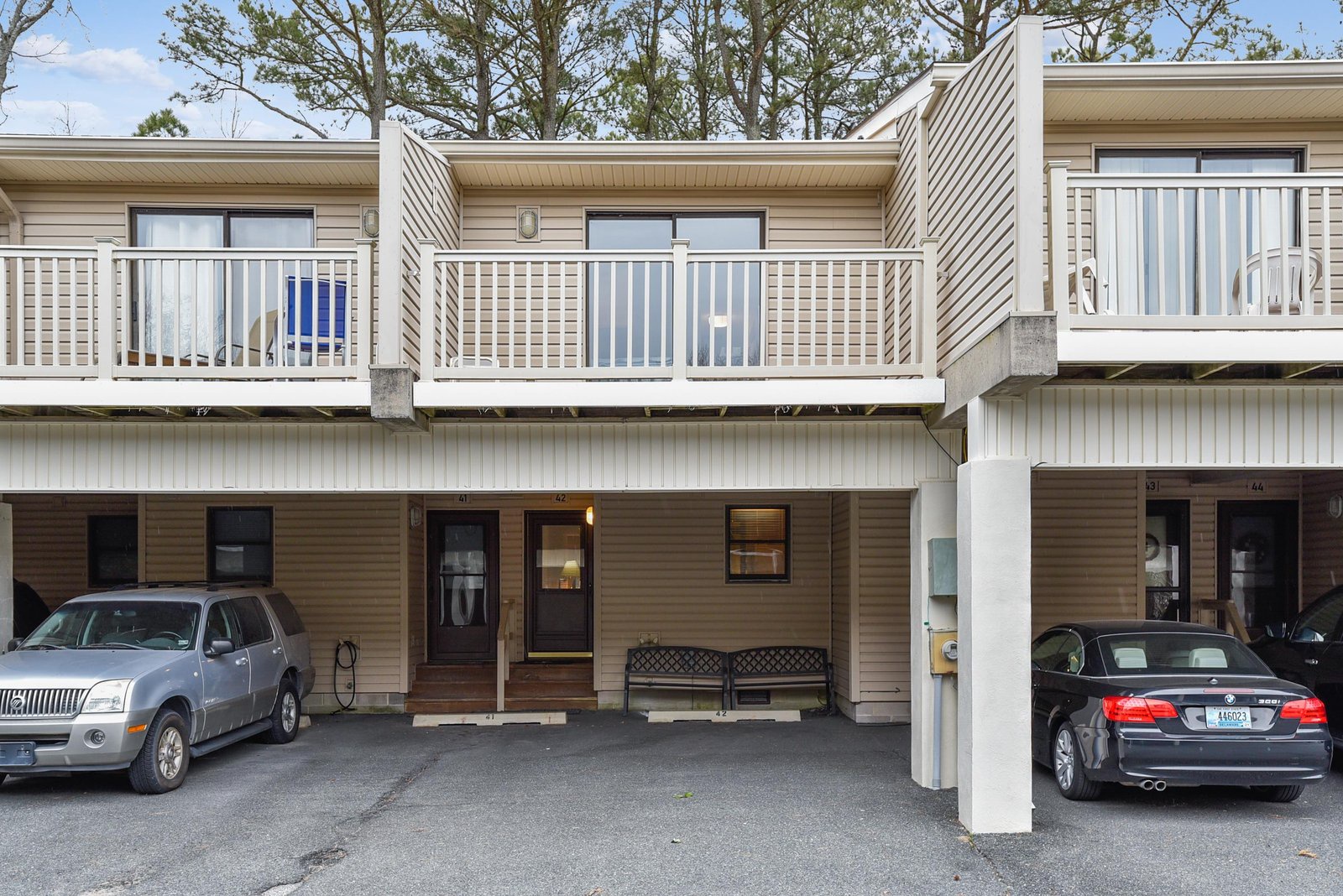 Multi-level townhome-style rental with private balconies, convenient parking, and tree-lined surroundings in a quiet residential setting.