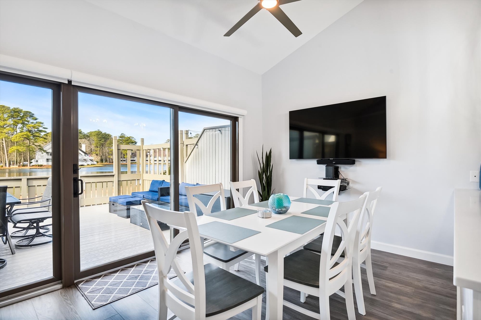 Your bright dining space opens to a waterfront deck, where morning coffee meets marina views and evening dinners unfold under coastal breezes.