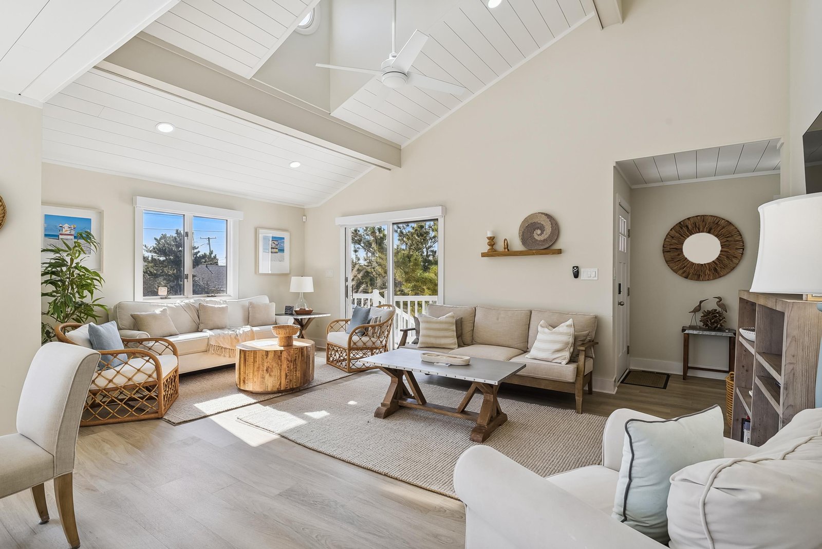 Settle into this bright, airy living room where vaulted ceilings and natural light create your perfect retreat. Relax on plush seating with ocean breezes drifting through the windows.