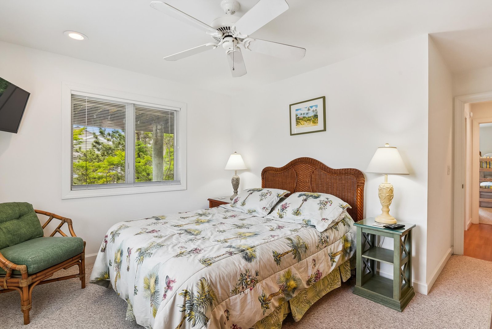 Your peaceful retreat features a comfy bed with botanical linens, gentle fan breezes, and soft natural light filtering in—perfect for unwinding after a day of adventures.