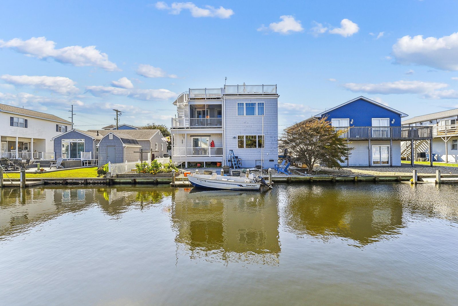 A charming waterfront property sits on a private canal with boat docking, offering direct access to the water and peaceful views of the surrounding neighborhood.