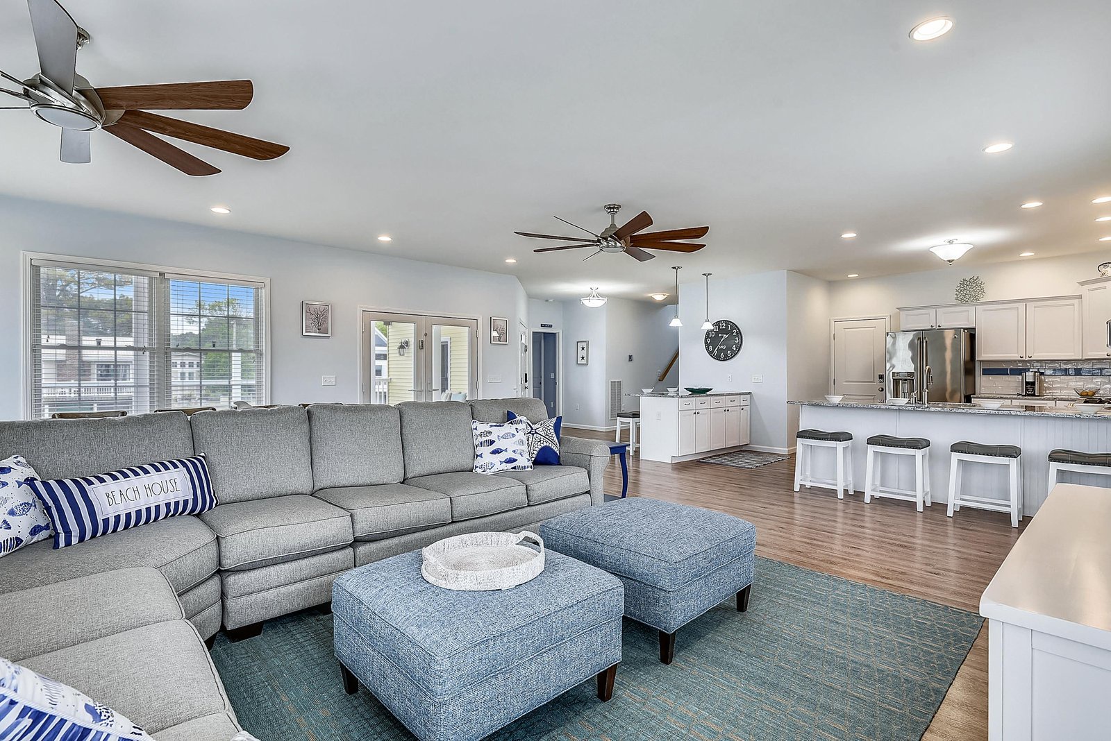 Unwind in your inviting open-concept living space, where coastal charm meets modern comfort. Plush seating, calming blues, and seamless flow into the fully equipped kitchen make this the perfect gathering spot for your beach getaway.