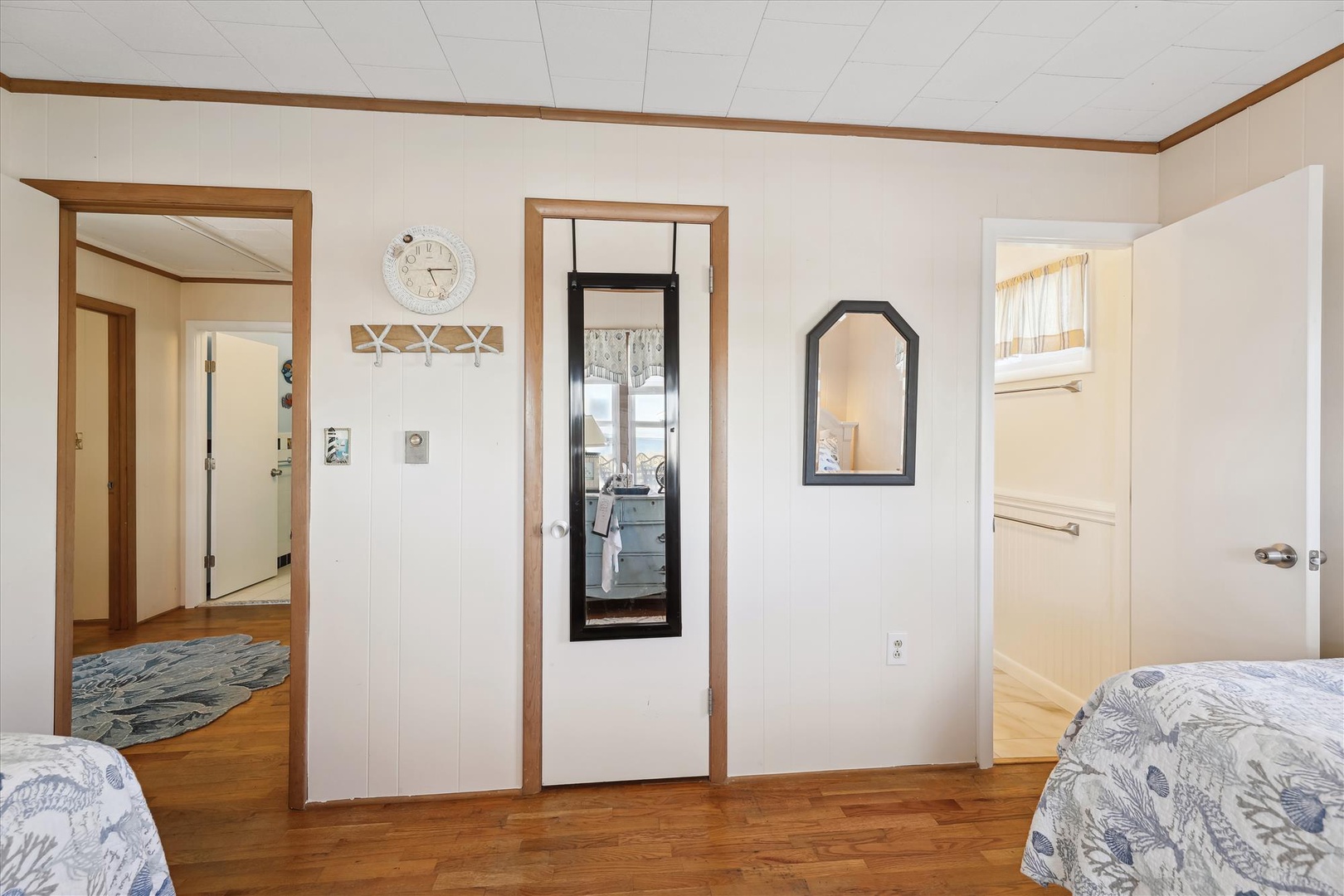 Your bright, welcoming bedroom features warm wood accents, cozy bedding, and charming coastal décor that makes unpacking feel like coming home.