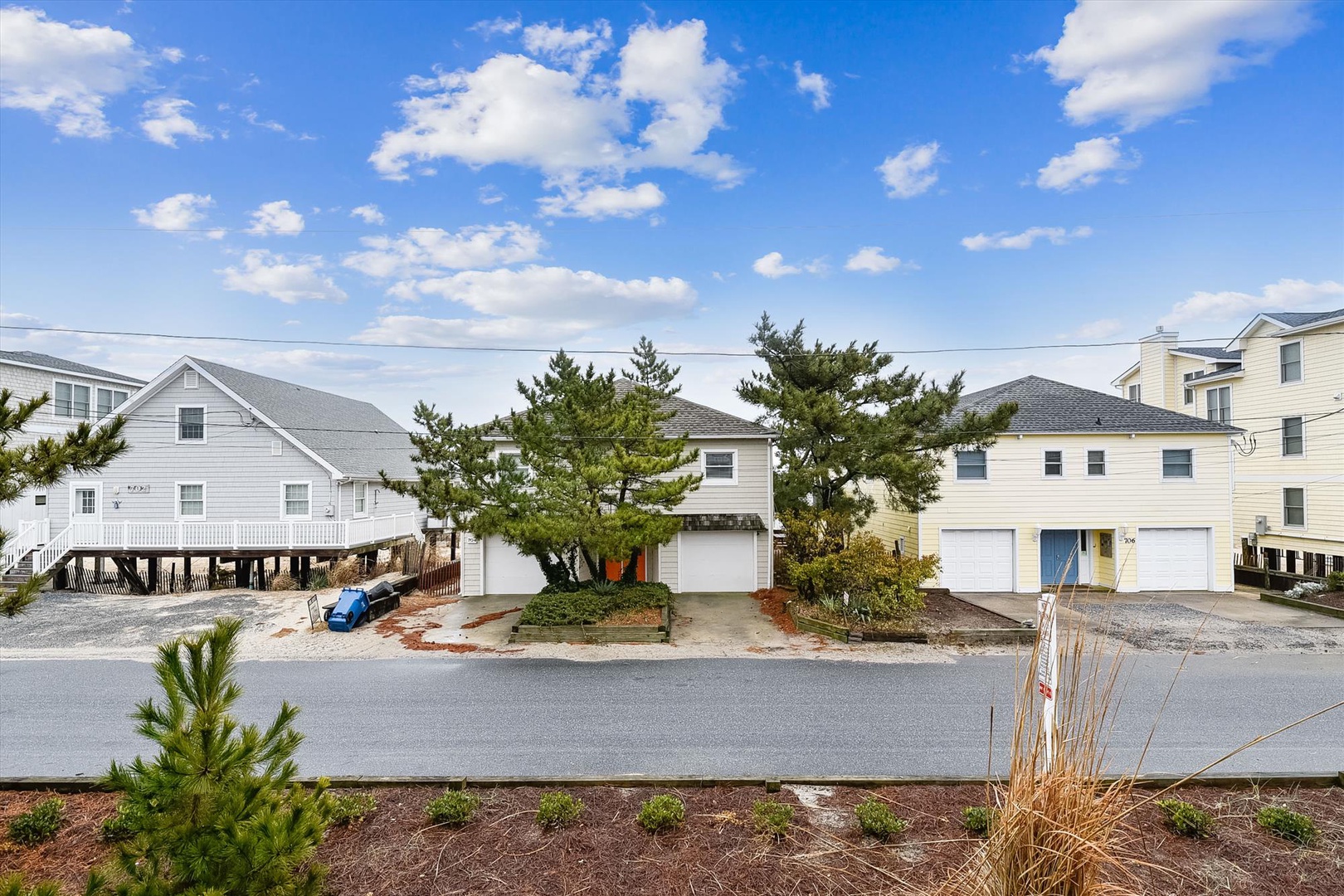 Coastal residential neighborhood with multiple vacation homes, situated near the beach and surrounded by mature pine trees. A peaceful area for your coastal getaway.