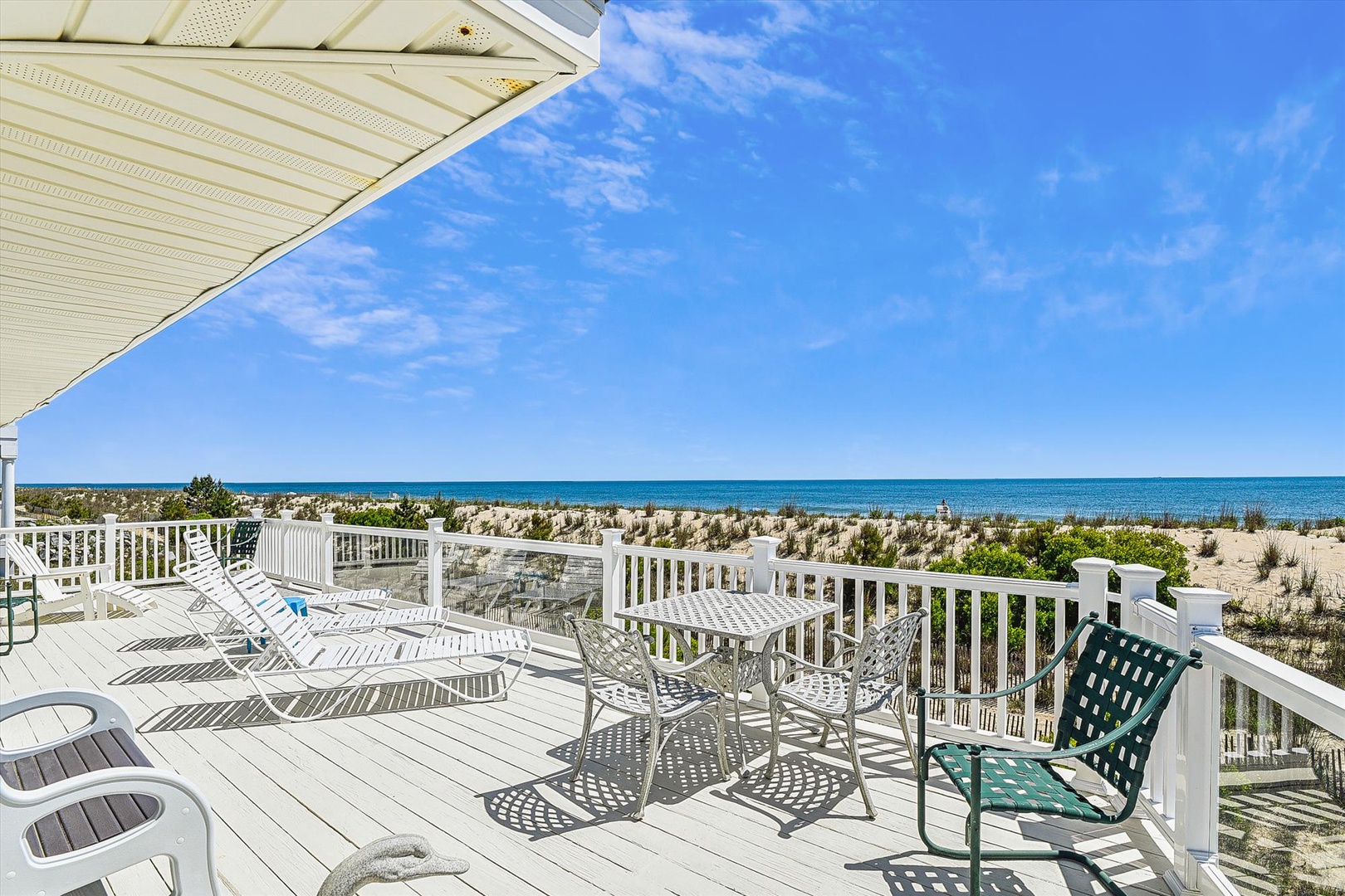 Step onto your spacious beachfront deck and sink into a lounge chair. The gentle ocean breeze, endless blue horizon, and soft sound of waves create your perfect coastal escape.