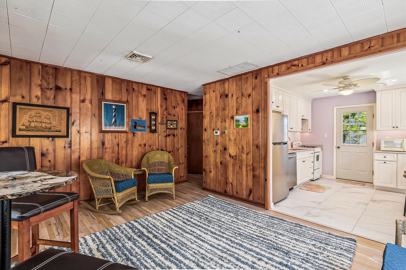 Relax in your cozy coastal retreat with warm knotty pine walls and nautical touches leading to a bright, fully-equipped kitchen for all your vacation meals.