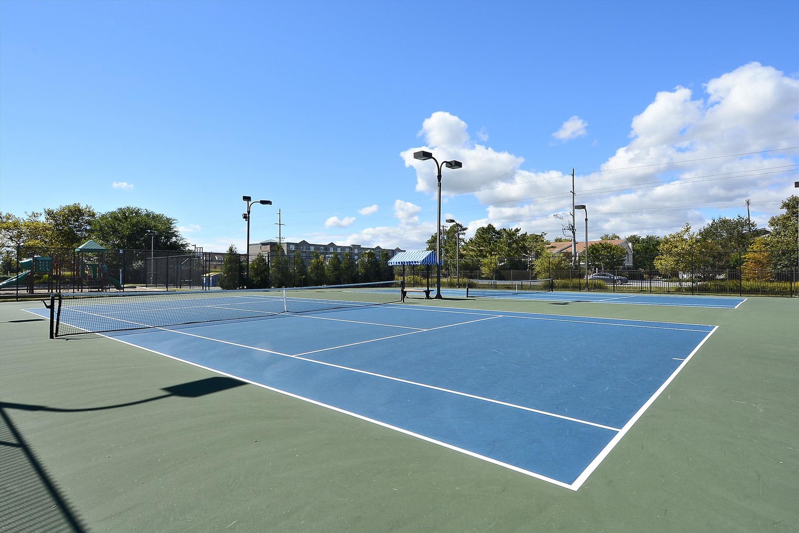 Beautifully maintained tennis courts are available for guests, featuring high-quality surfaces and professional lighting for day or evening play in a peaceful, tree-lined setting.
