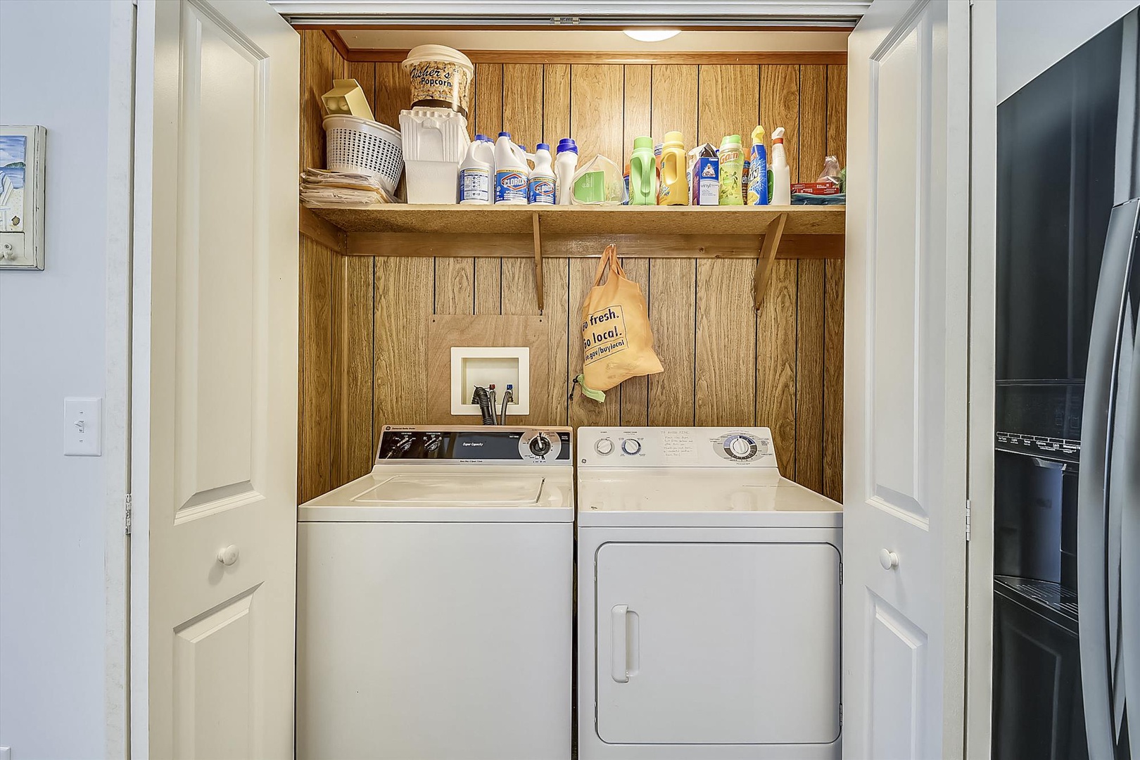 Your private laundry closet is stocked and ready, making longer stays feel effortless with a washer, dryer, and all the essentials neatly organized above.