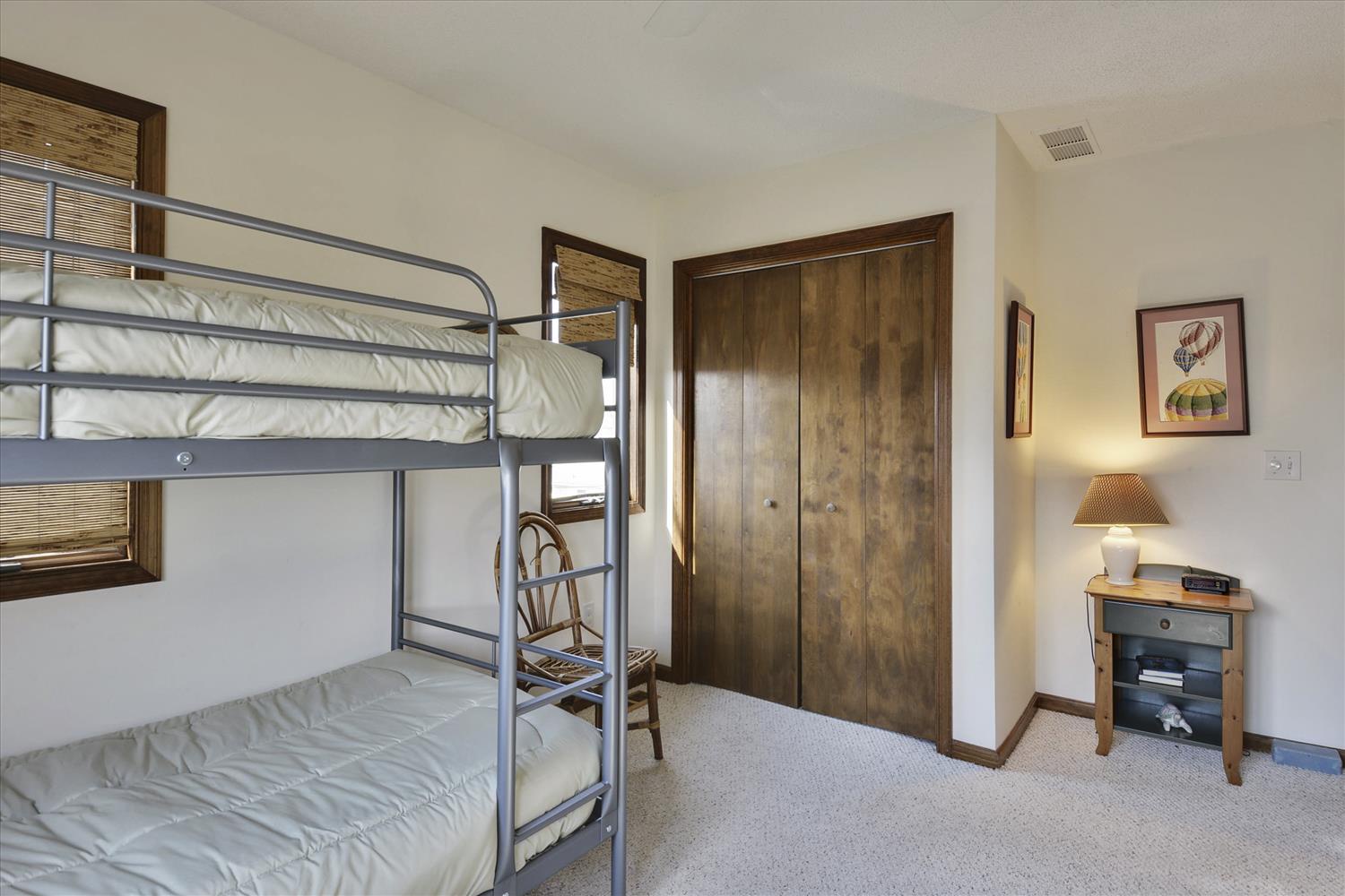 Your cozy bunk room awaits with plush bedding and warm wood tones, perfect for families or friends sharing the adventure together.