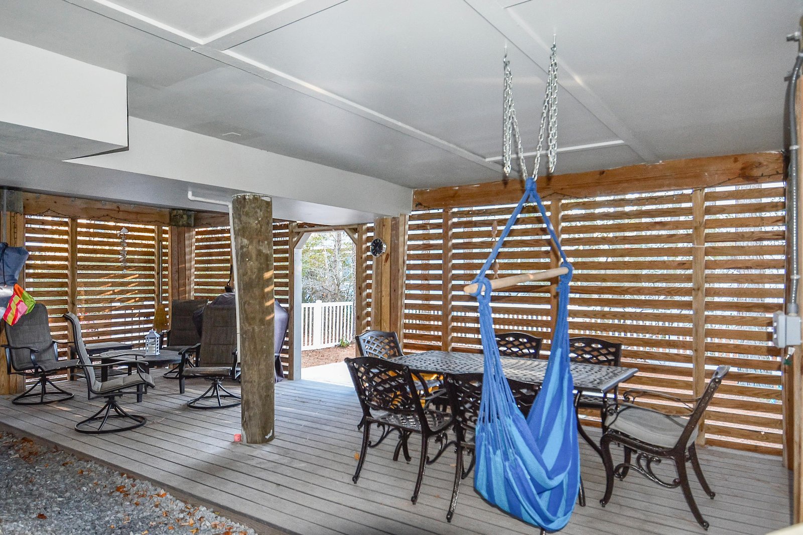 A covered outdoor deck offers your perfect retreat with dining space, loungers, and a playful swing—ideal for morning coffee or evening gatherings under the shelter.