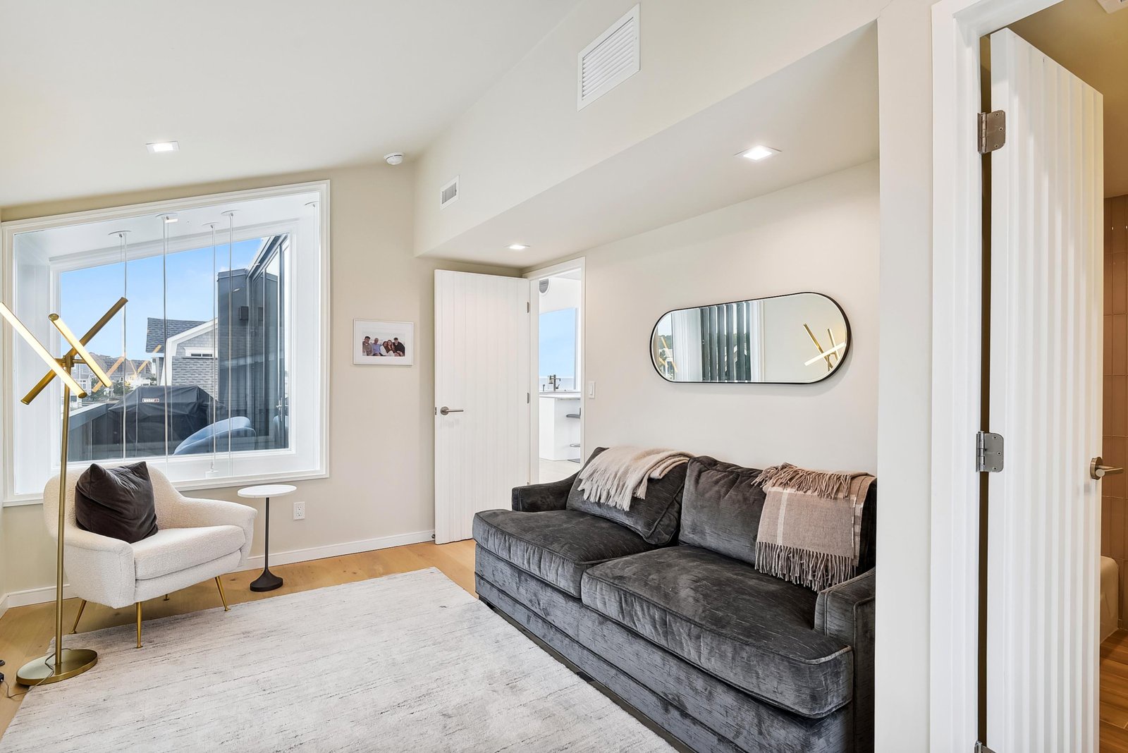 Unwind in your stylish living area with plush velvet seating and natural light streaming through the windows—perfect for relaxing after exploring the city.