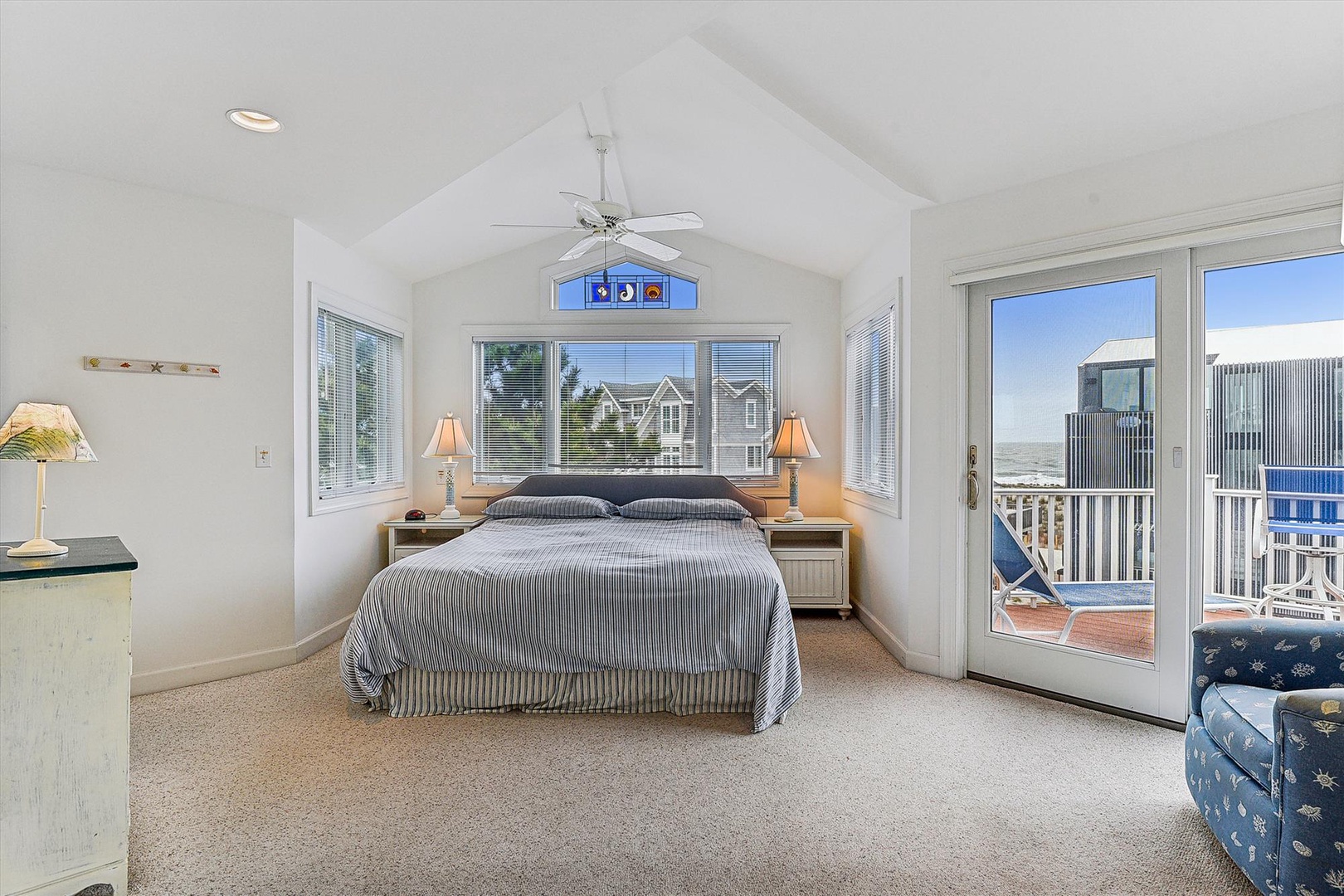 Wake up to soft coastal breezes and natural light streaming through your private balcony doors. This serene retreat offers soaring vaulted ceilings and a cozy reading nook—your peaceful escape by the sea.