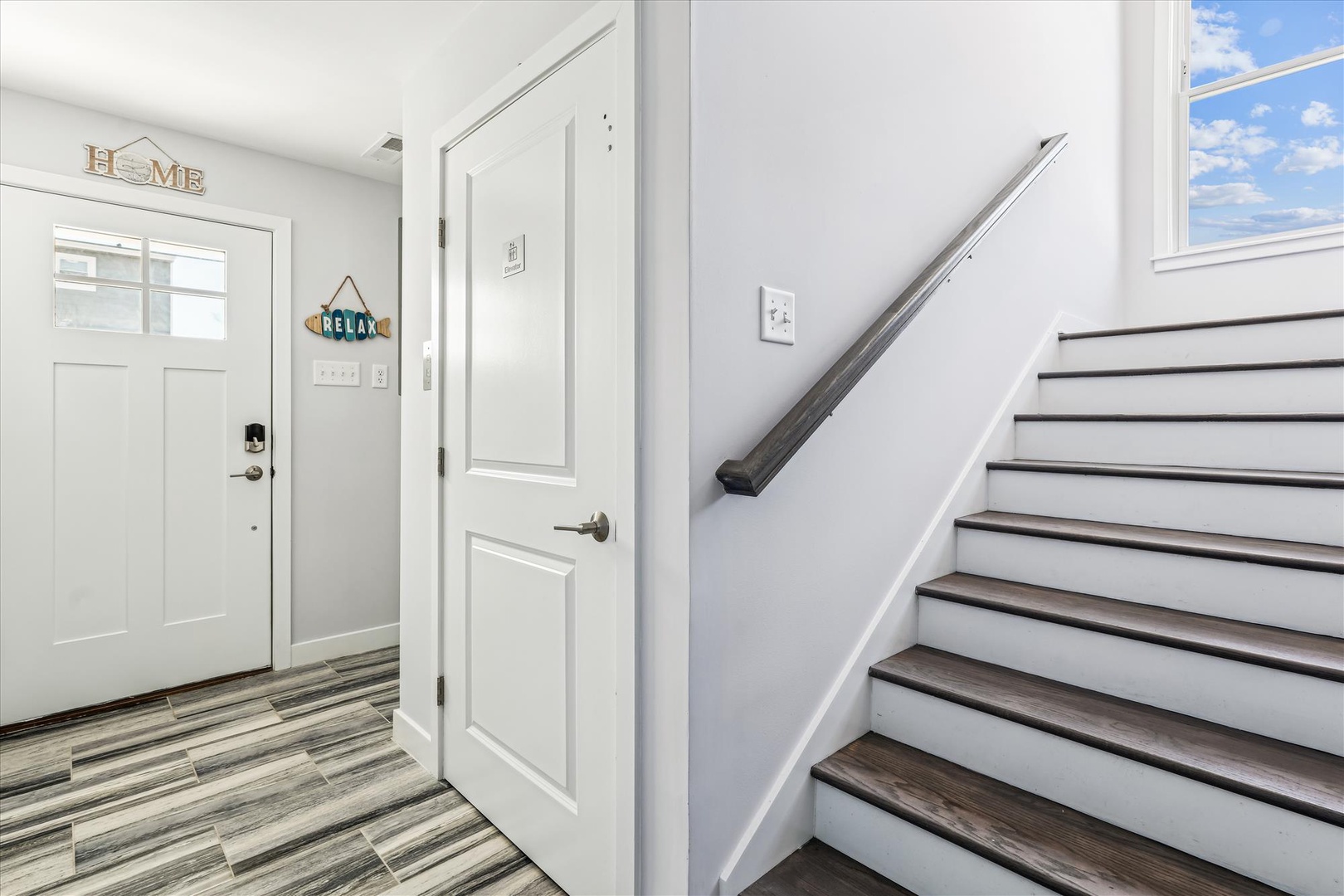 Step into your home-away-from-home where a welcoming entrance and bright stairway invite you to explore every corner of this thoughtfully designed space.