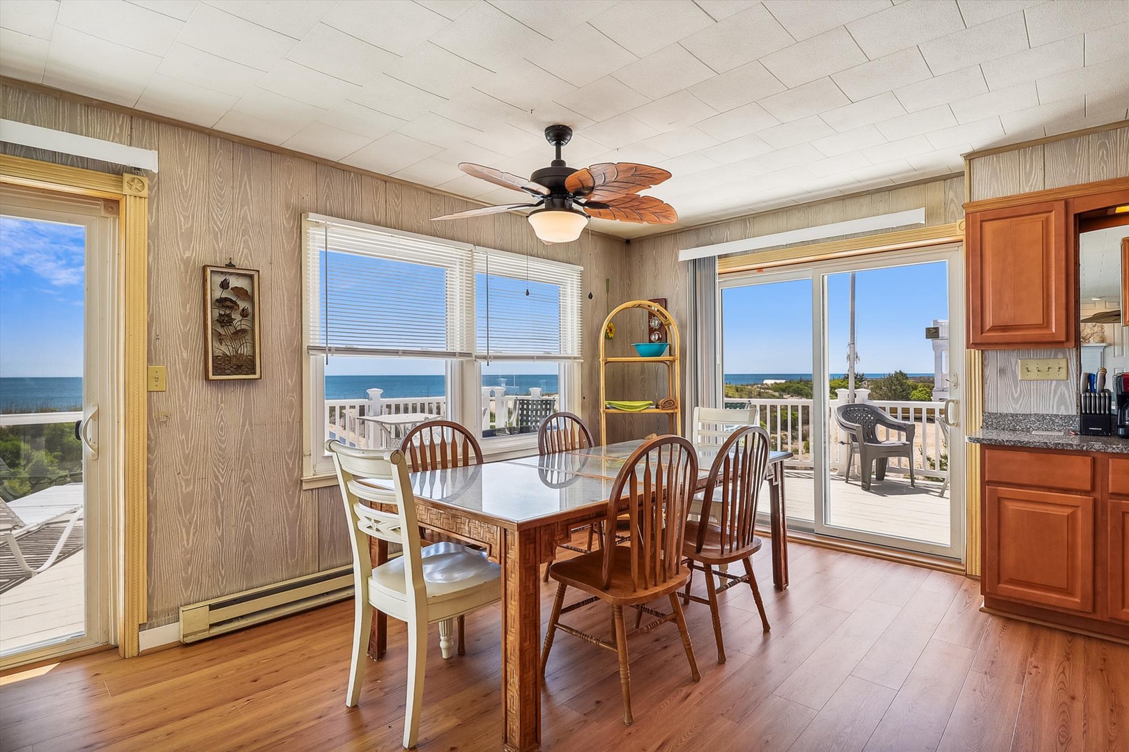 Picture yourself enjoying meals at this welcoming dining table while the ocean breeze drifts in through open doors, framing stunning coastal views that make every bite taste better.
