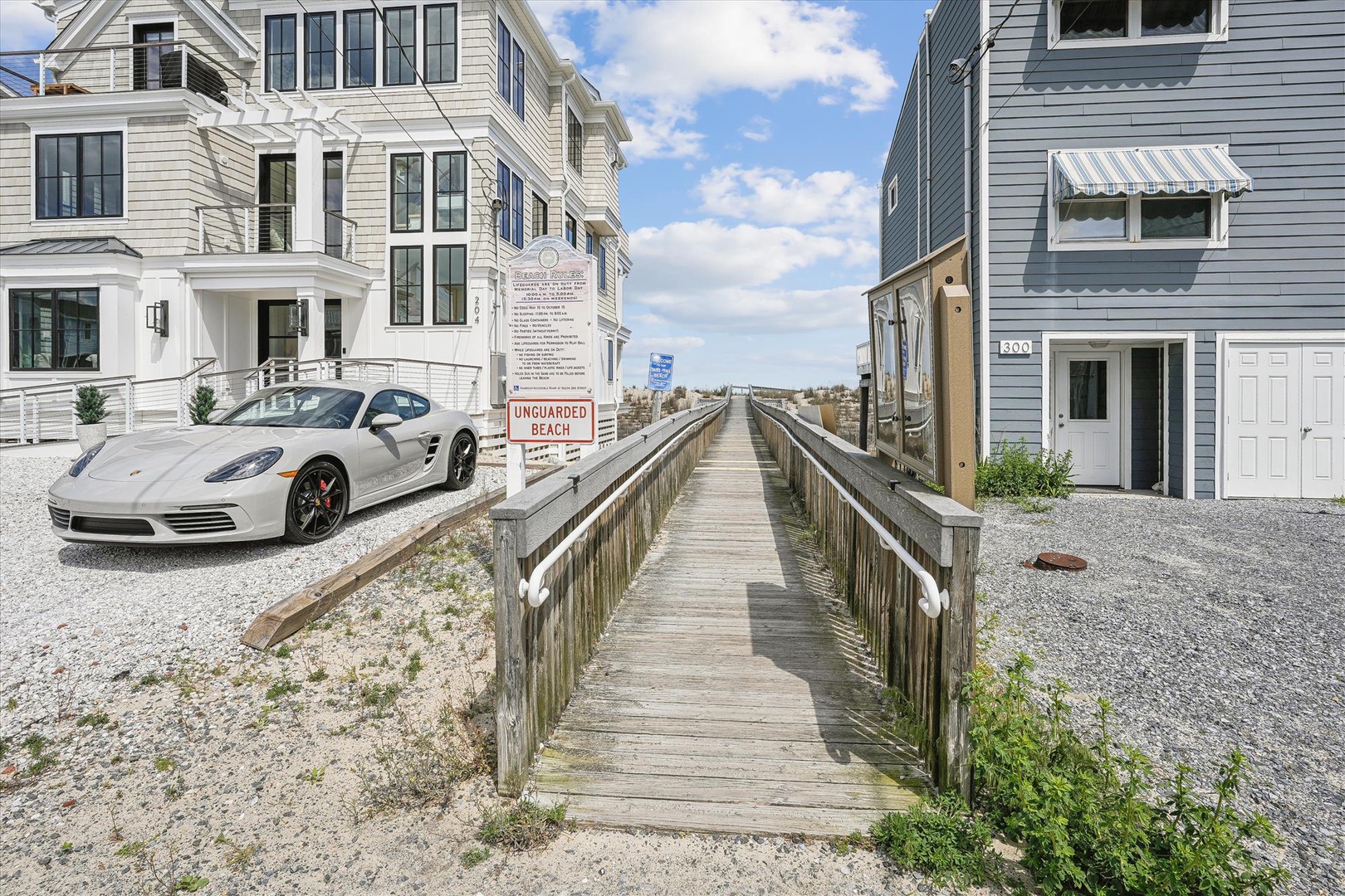 Beachfront property with direct boardwalk access to an unguarded beach, located in a quiet coastal neighborhood with nearby landmarks and street views.