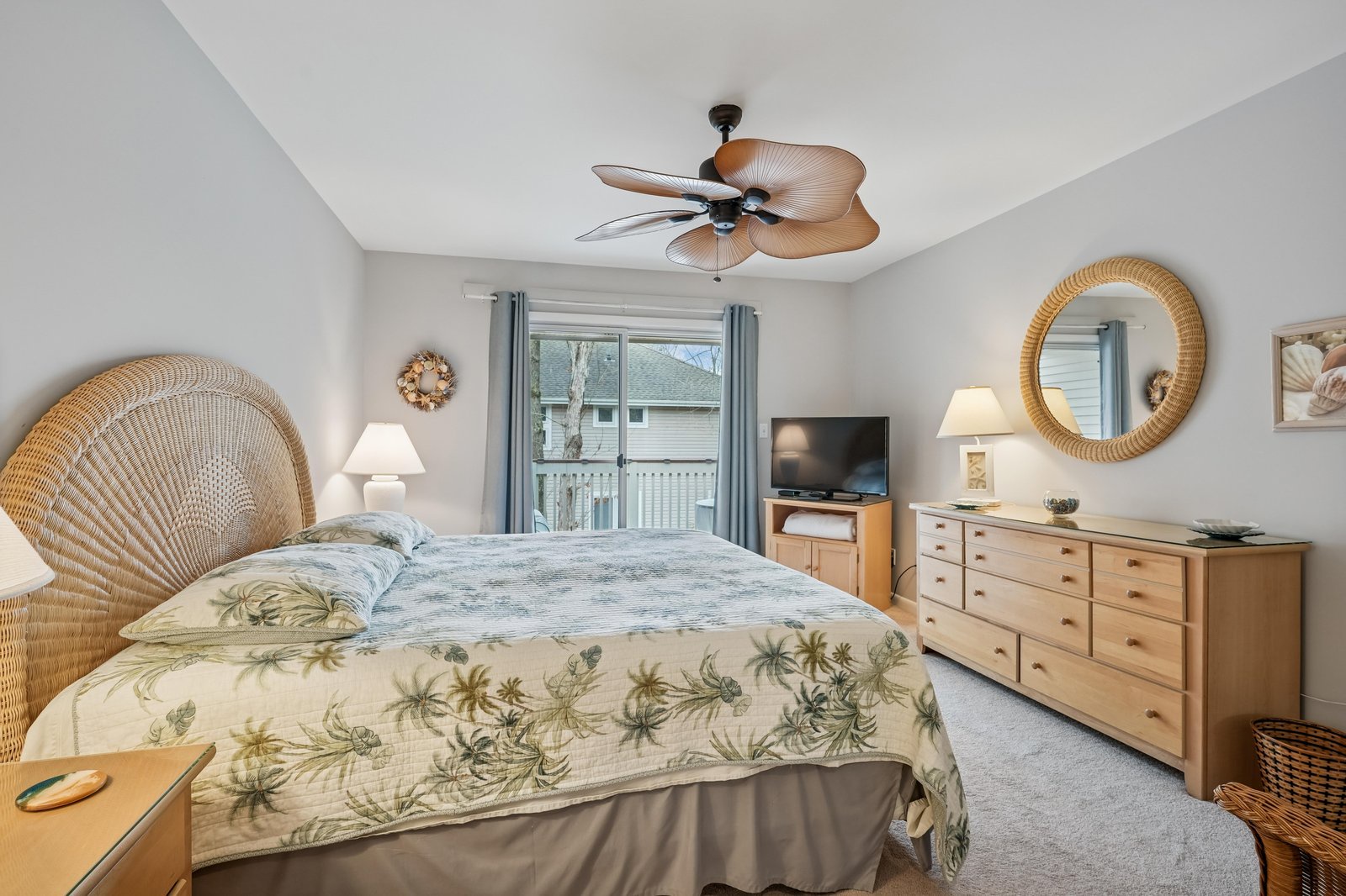 Your coastal-inspired bedroom offers a tranquil retreat with a plush bed, tropical ceiling fan, and soothing natural tones. Wake to soft light and enjoy your favorite shows before stepping outside.