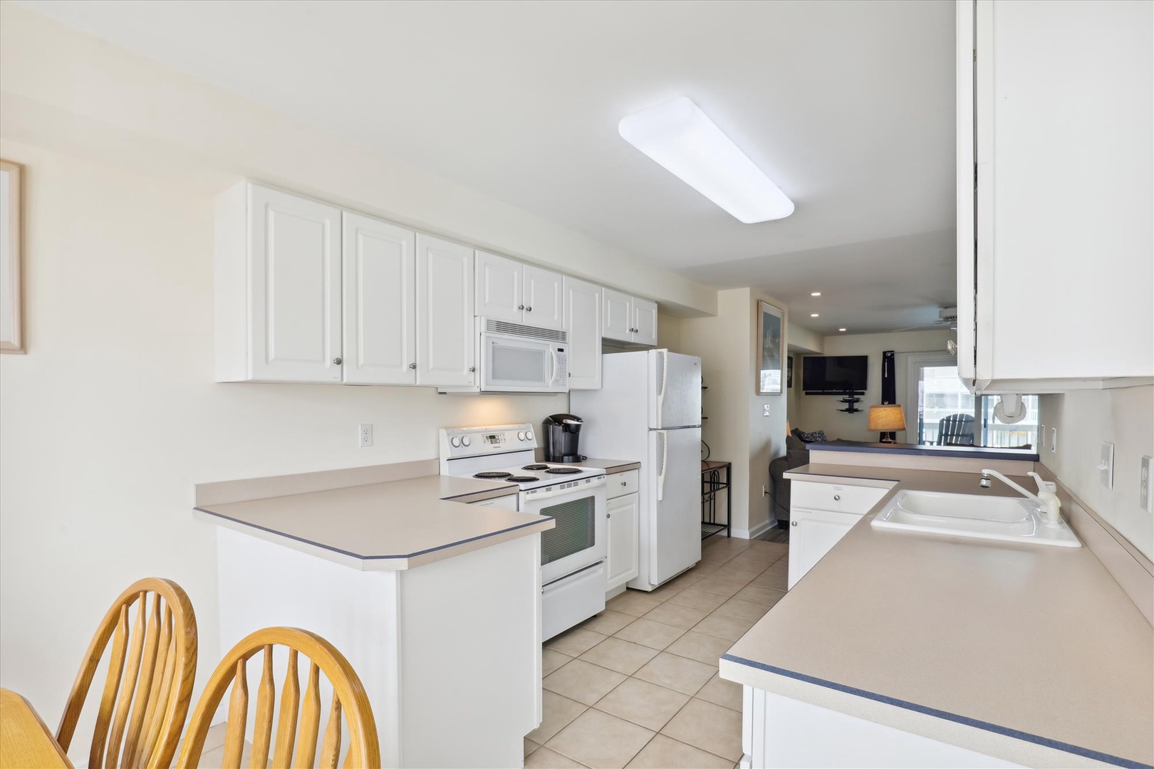 Step into your bright, open-plan kitchen fully equipped with modern appliances and ample counter space for preparing your favorite meals together.