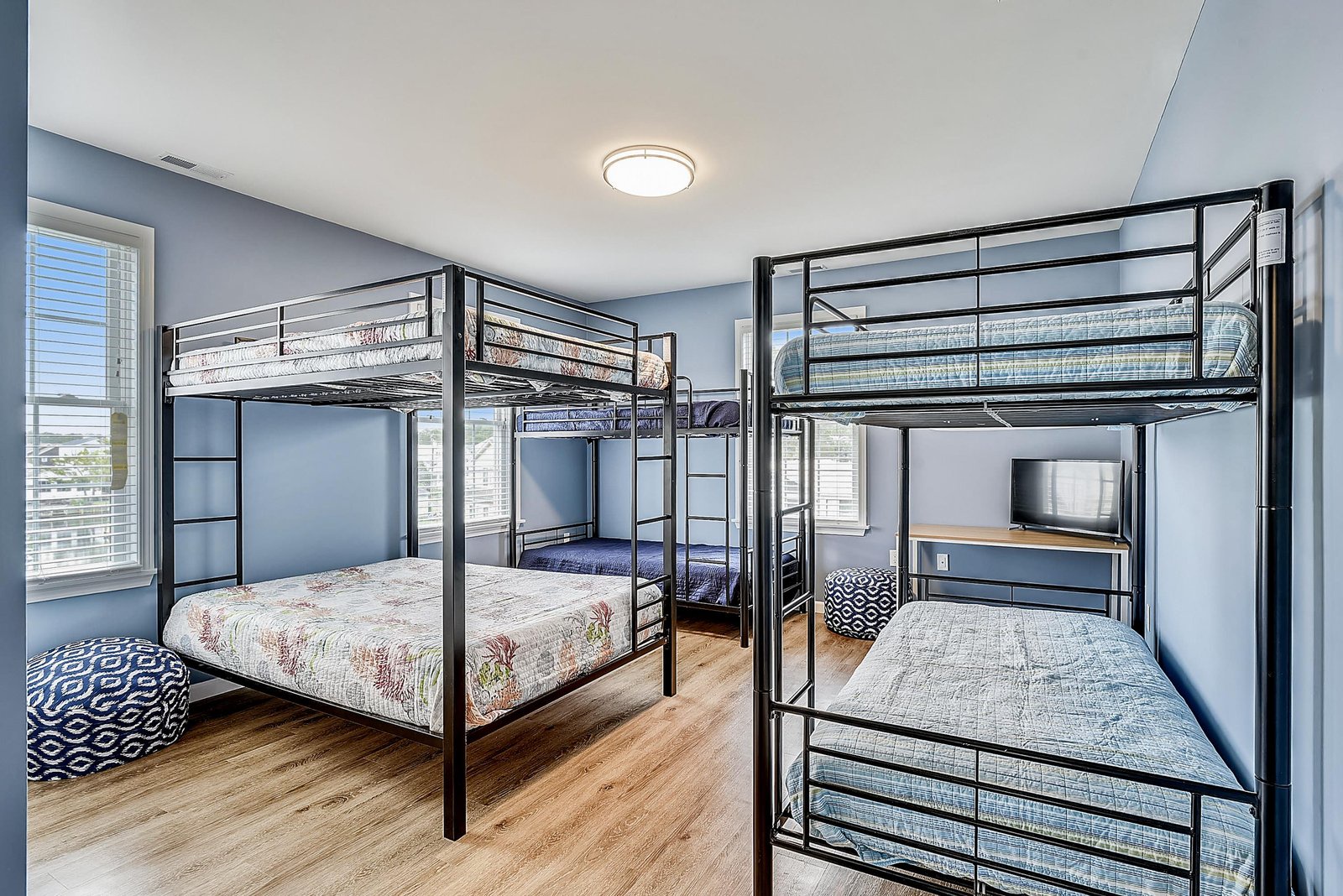 Your crew will love this spacious bunk room with fresh blue walls and comfy sleeping spots for everyone.