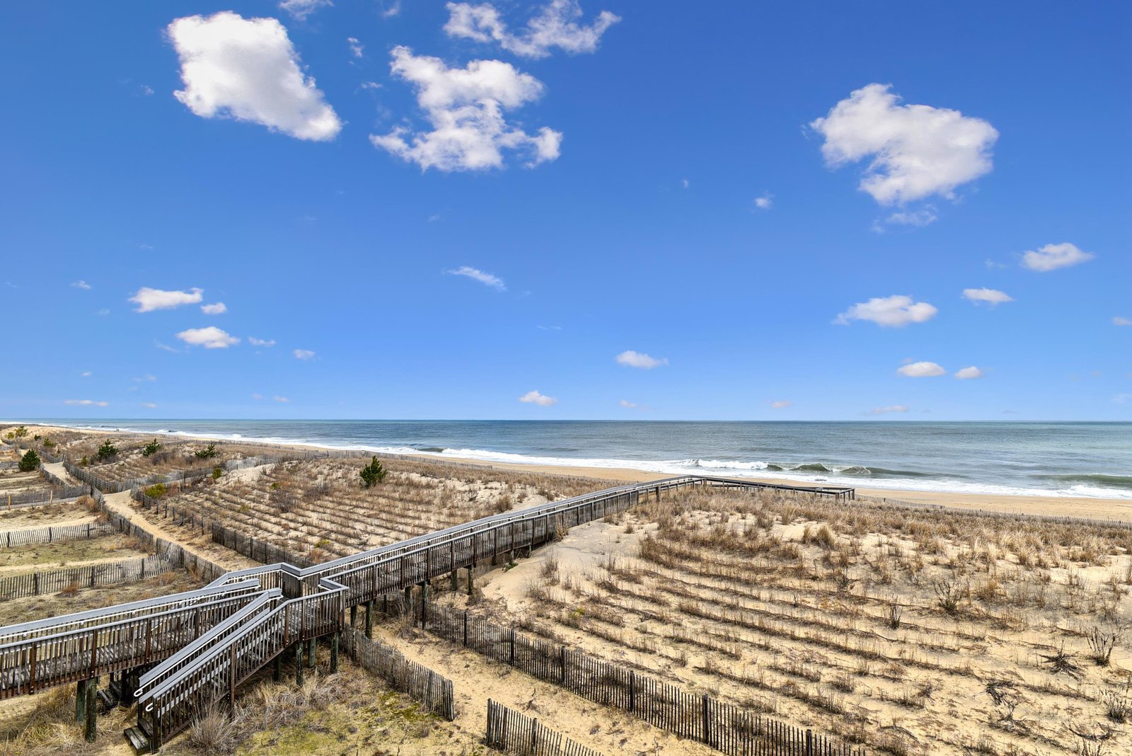 The property sits moments away from a beautiful stretch of Atlantic coastline, with boardwalk access leading to a pristine sandy beach bordered by dunes and protected vegetation.