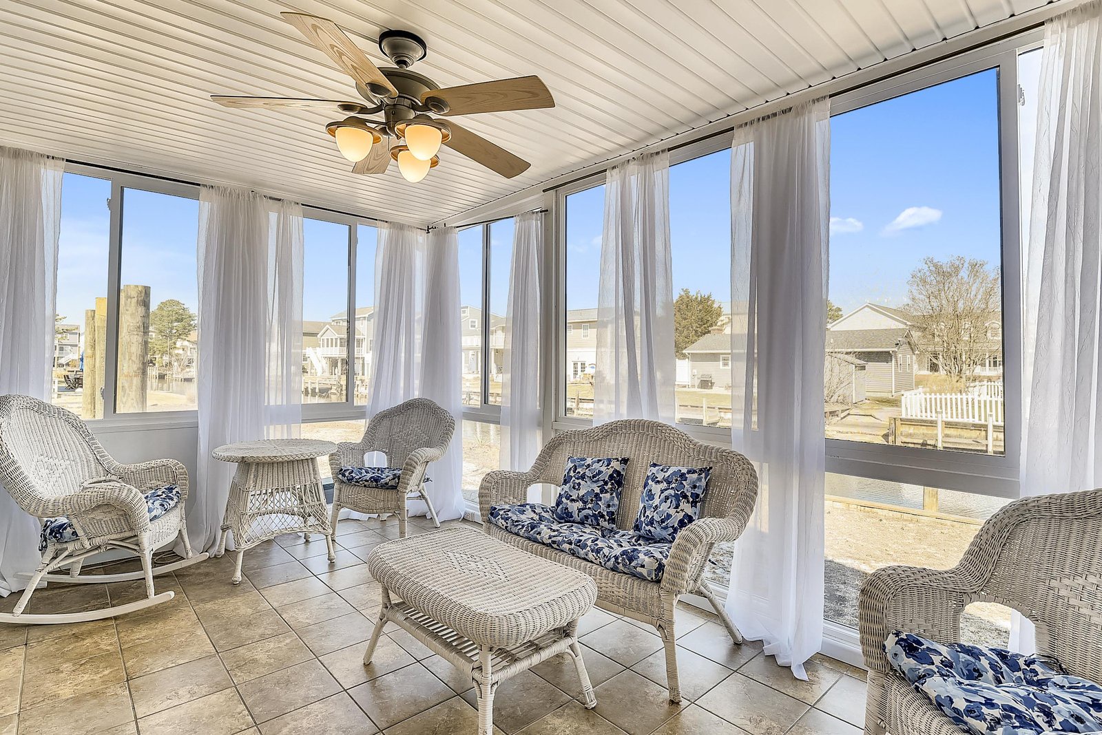 Step into your private sunroom where soft breezes flow through open windows and comfortable wicker seating invites you to relax with morning coffee or an afternoon read.