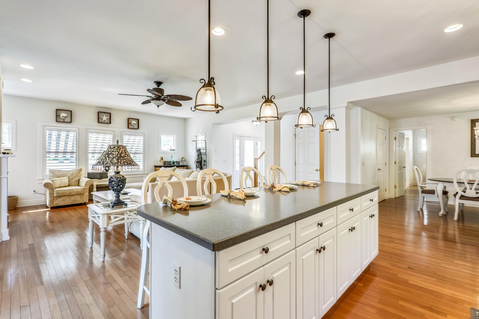 You'll love gathering in this bright, open-concept space where the kitchen flows seamlessly into the living and dining areas, perfect for group meals or relaxing together.