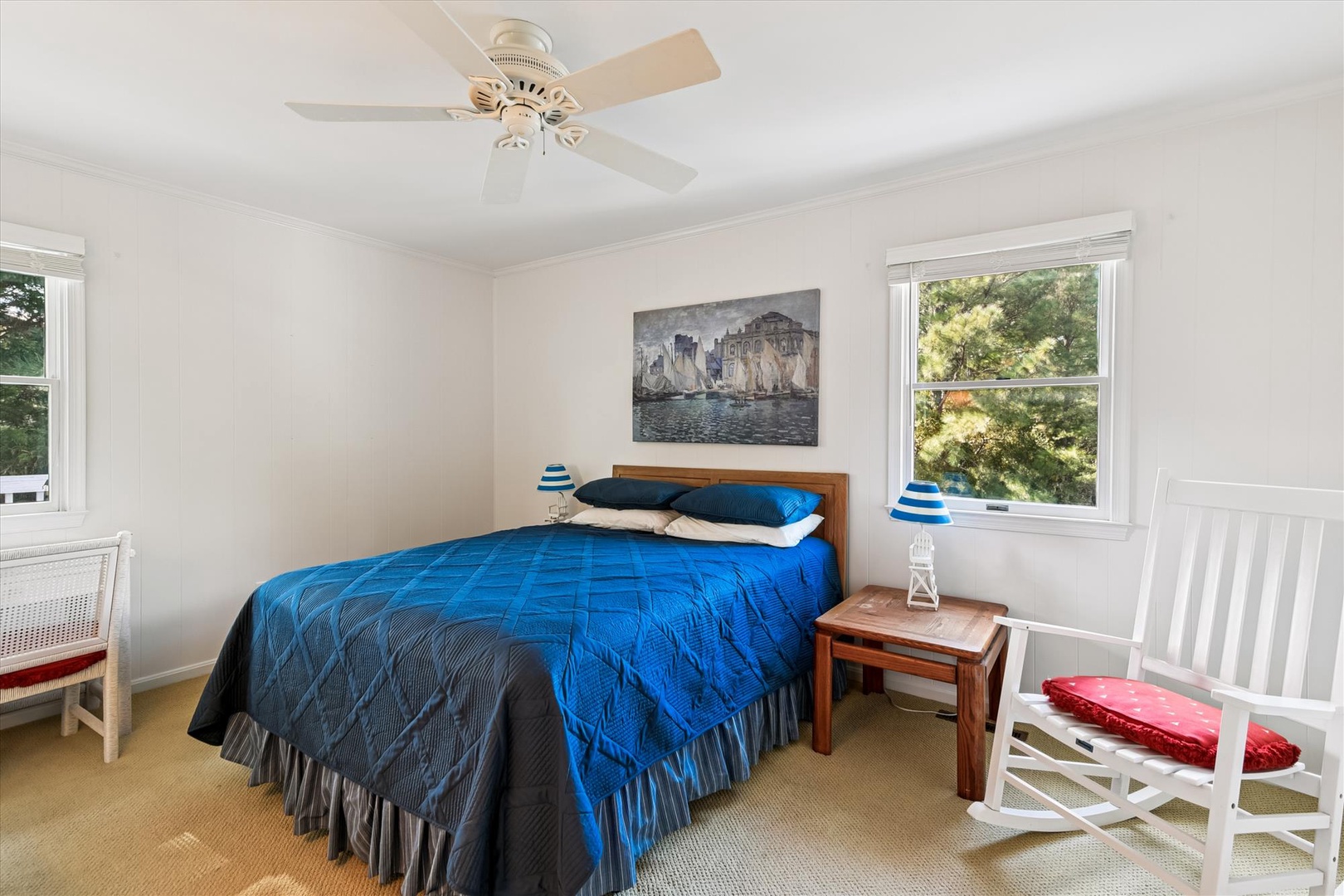 Your coastal bedroom features peaceful blue tones and gentle ceiling fan breezes for comfort during warm nights.
