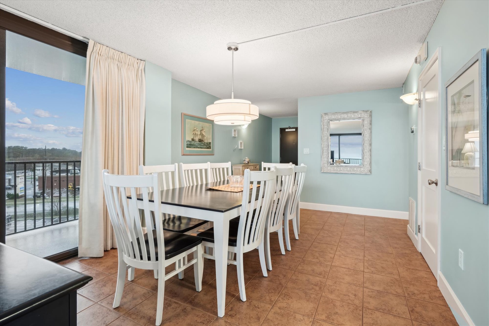 Gather your family around this elegant dining table while enjoying waterfront views through floor-to-ceiling windows.