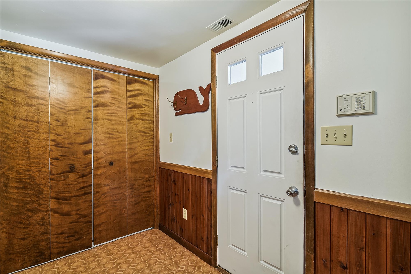 A welcoming entryway with ample storage and charming wood accents sets the stage for your mountain retreat, offering convenient space to stow away your gear after a day of adventure.