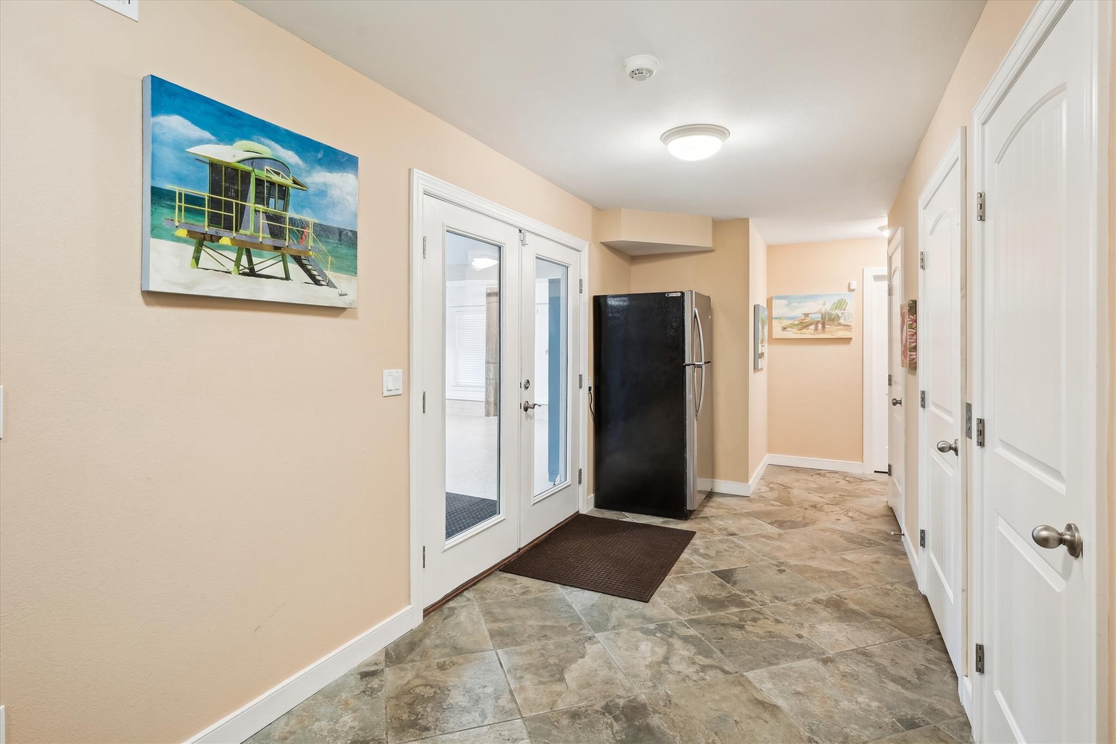 Step inside your bright, welcoming entryway with beach-themed artwork and easy tile floors leading to all your vacation spaces.