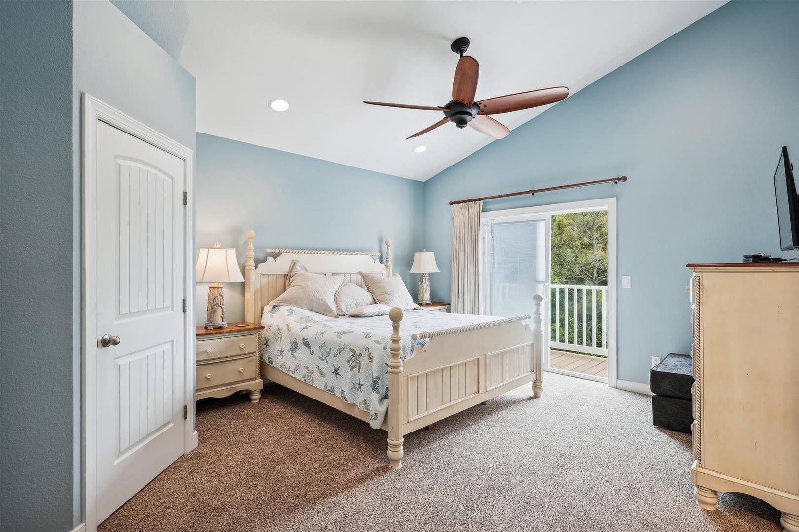 Drift off in this serene coastal-style bedroom where calming blue walls, soft linens, and gentle breezes invite your most restful nights. Your private balcony opens to peaceful tree-lined views.