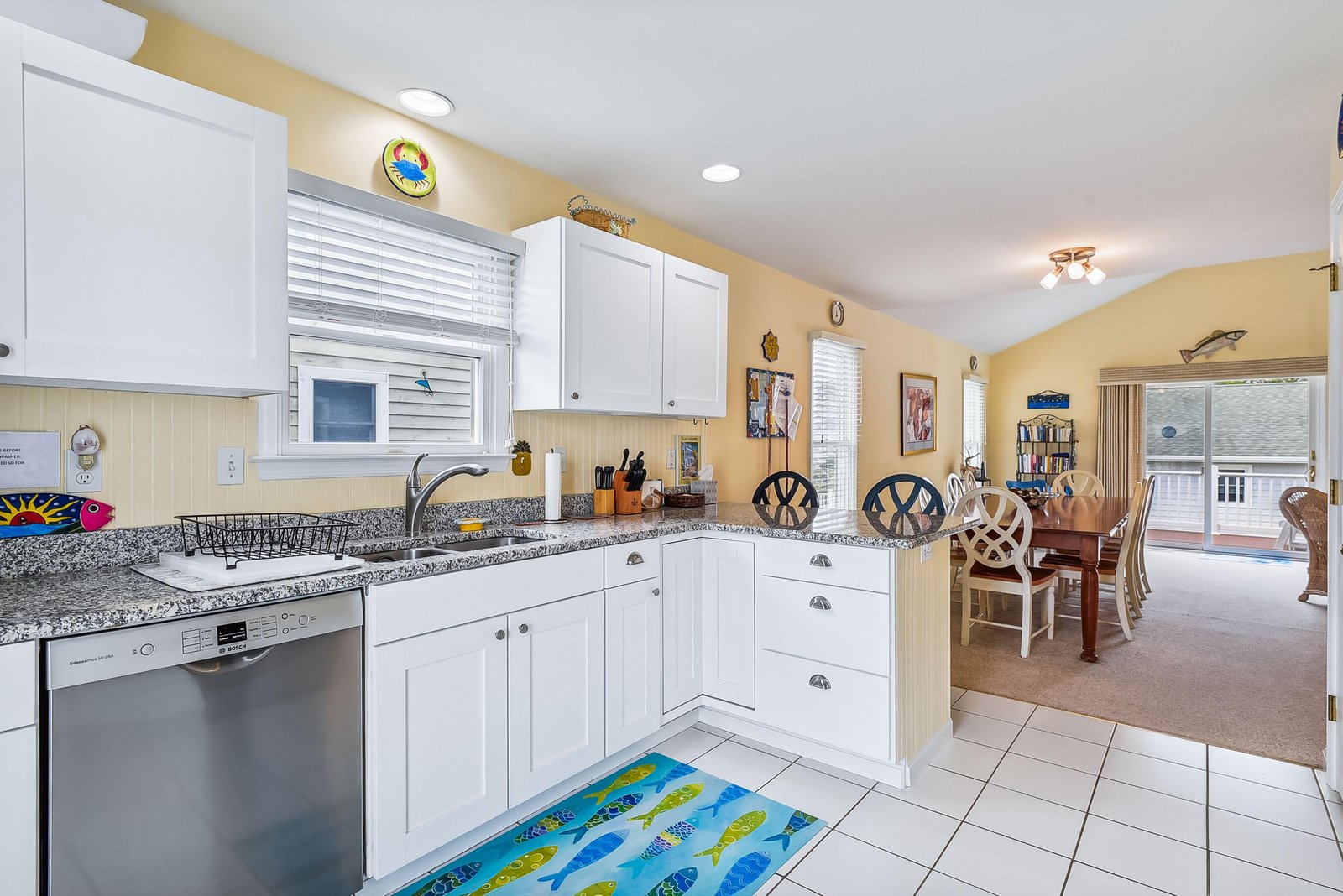 Step into your bright, fully equipped kitchen with modern appliances and granite countertops, flowing seamlessly into a welcoming dining area—perfect for preparing meals and gathering together.