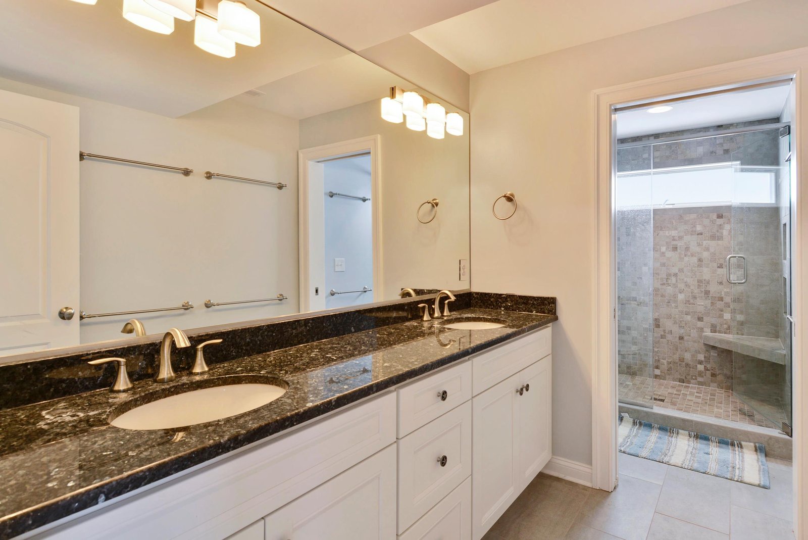 Your spacious bathroom features elegant granite countertops, dual sinks, and a luxurious walk-in shower with stone tile—perfect for unwinding after a day of exploring.