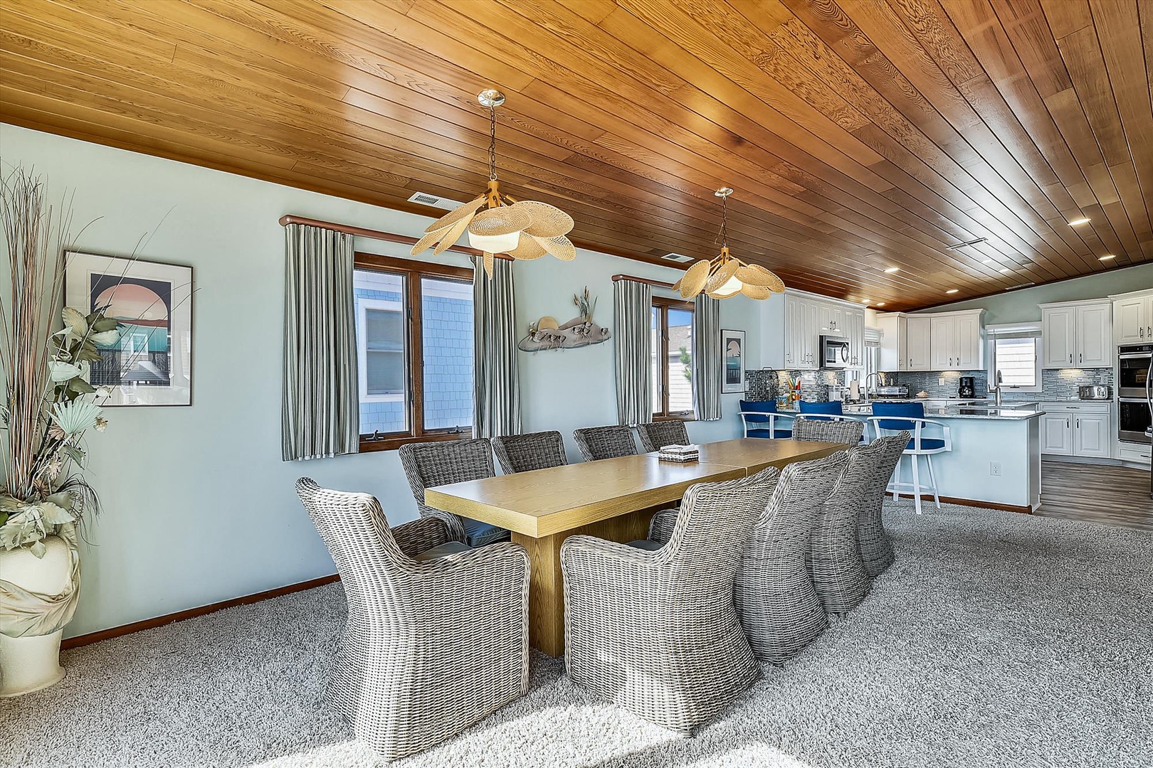 Gather everyone around the handsome oak table beneath warm wood ceilings and elegant lighting, where your group can share meals and stories together in this beautifully appointed open-concept space.