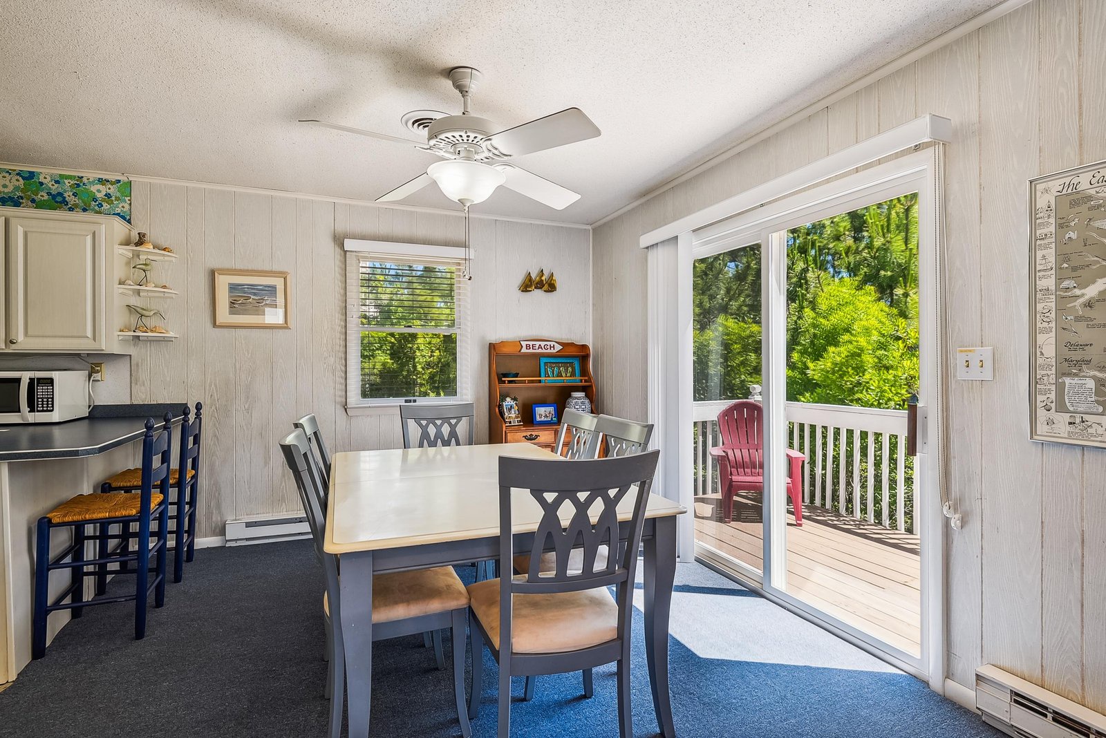 Step into your cozy dining space, where casual meals feel special. Bright windows and sliding glass doors open to your private deck—perfect for morning coffee or evening relaxation surrounded by lush greenery.
