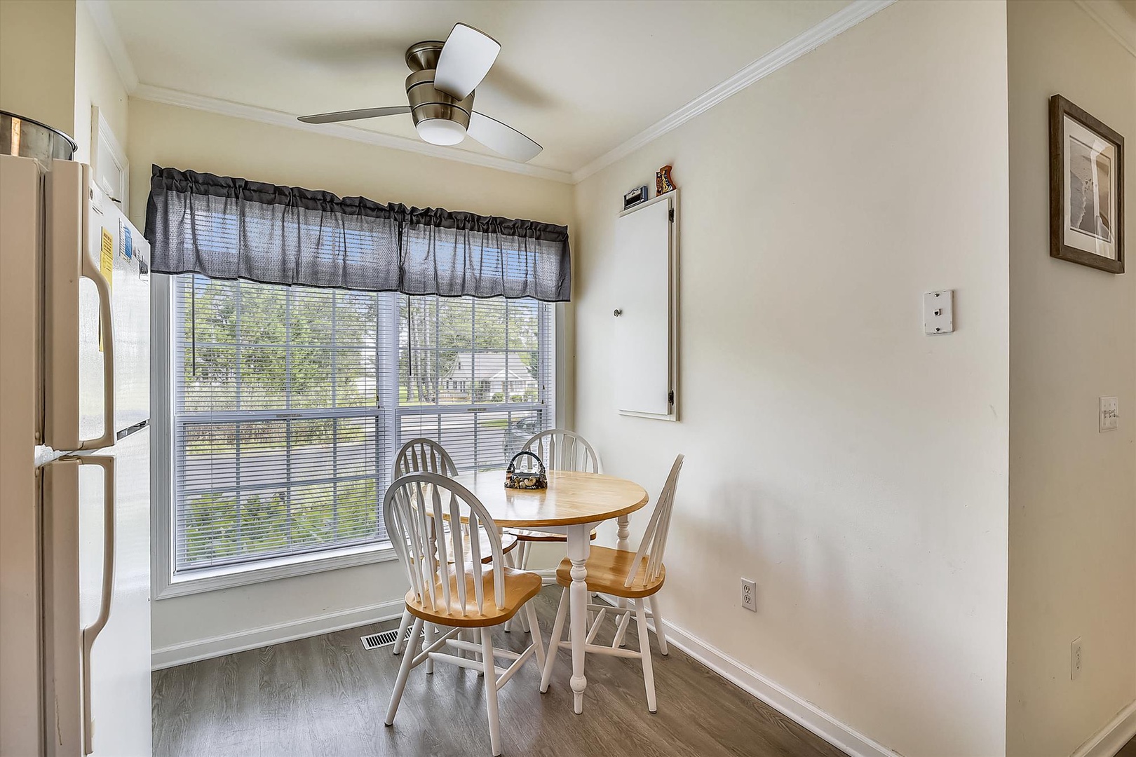 Enjoy morning coffee at this charming breakfast nook with natural light streaming through the window, creating a bright and welcoming start to your day.