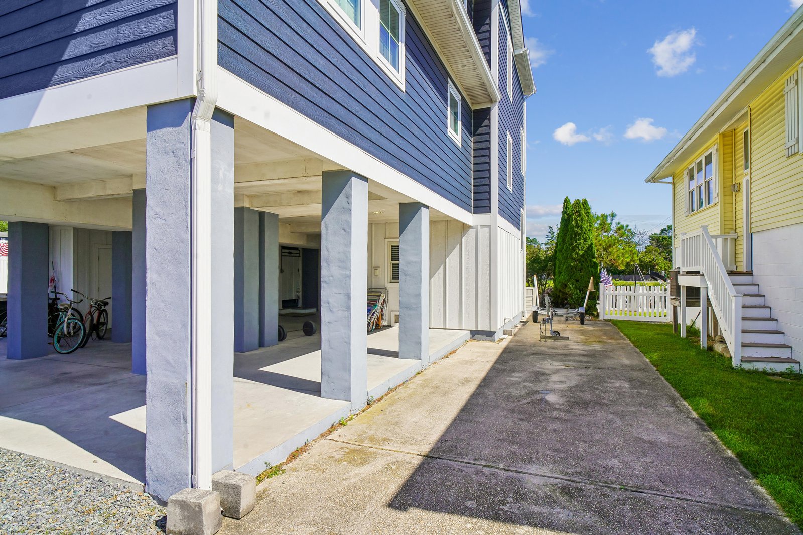 The property sits in a friendly residential neighborhood, featuring covered parking and easy ground-level access beneath the main living space.