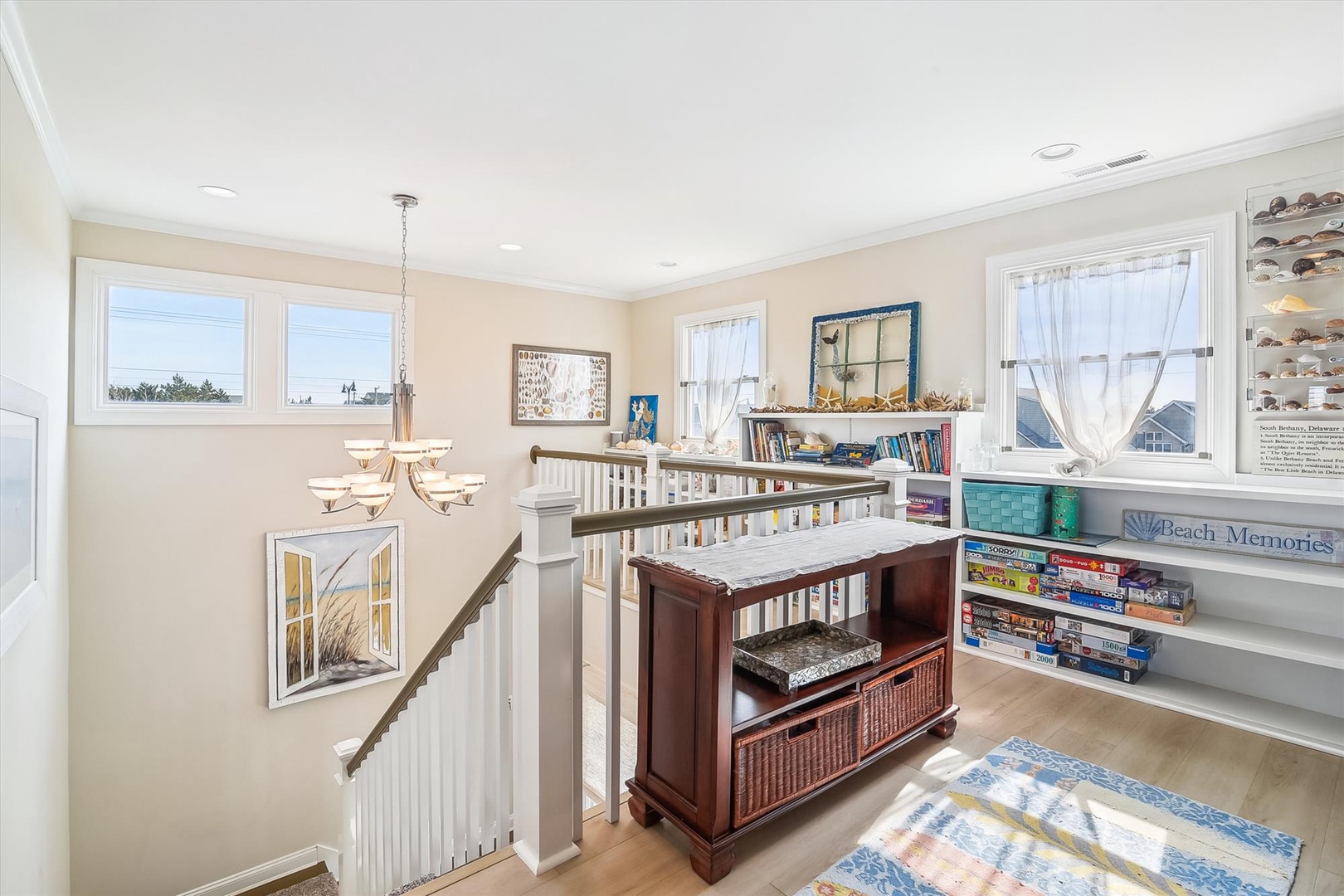 Bright hallway filled with coastal charm, perfect for relaxing with books, games, and seashell collections displayed throughout your stay.