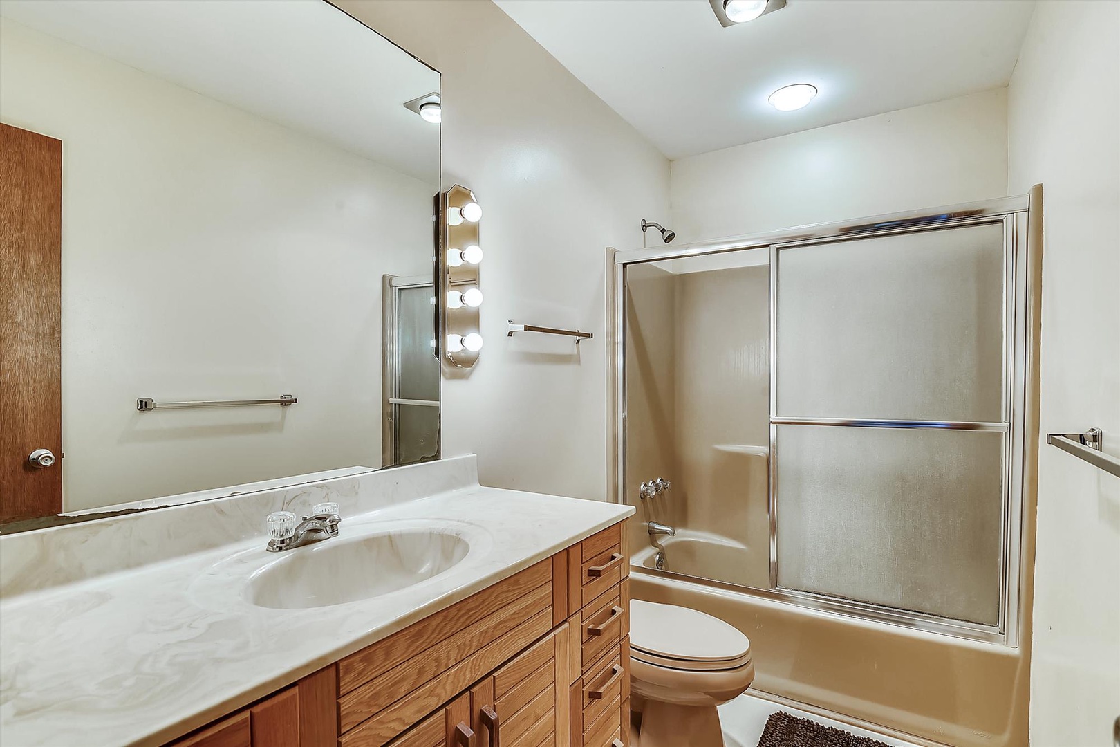 Step into your spacious bathroom with dual sinks, fresh towels, and a relaxing shower-tub combo—perfect for unwinding after a day of adventure.