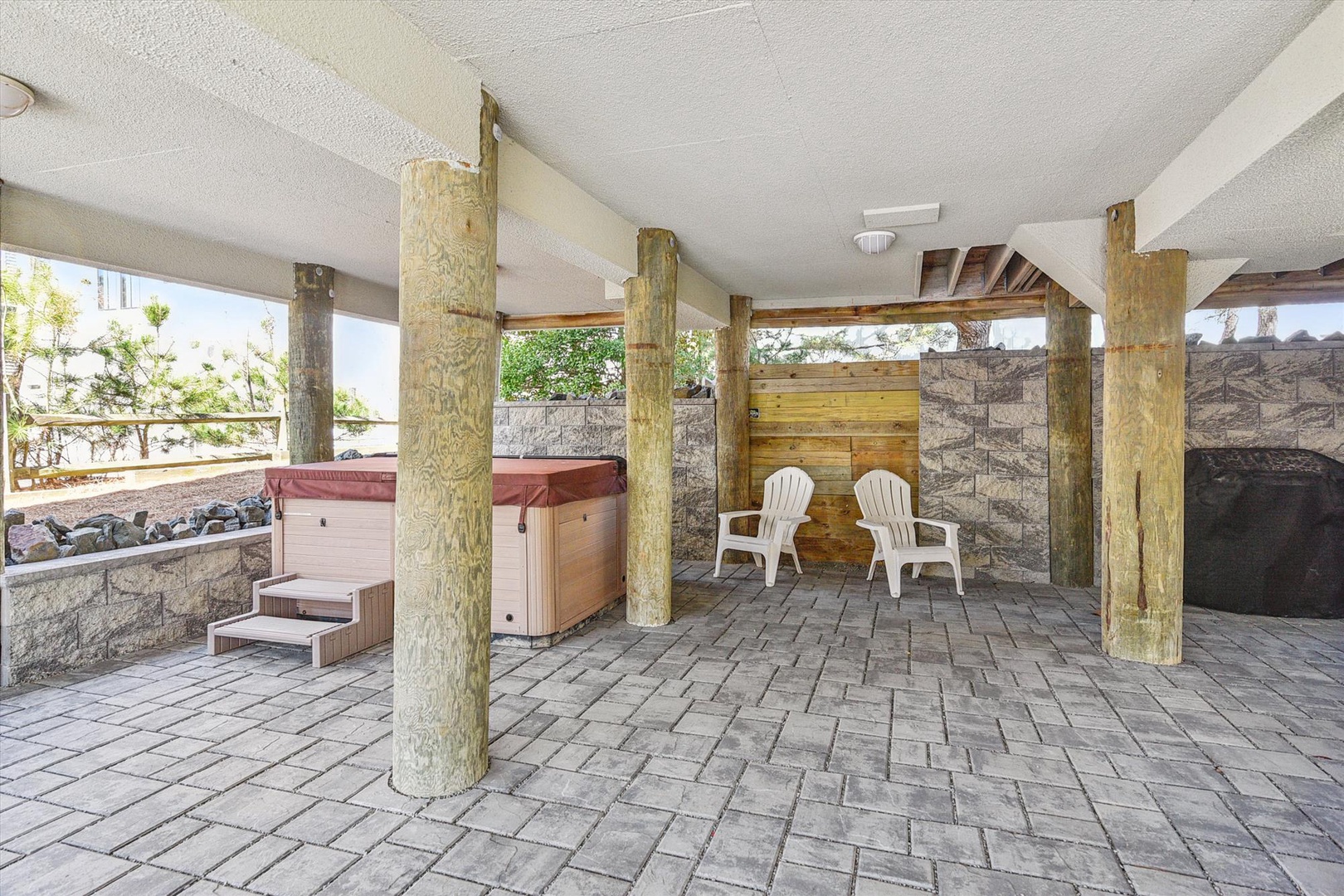 Unwind in your private hot tub surrounded by natural stone and wood accents, with a second soaking spot just steps away for ultimate relaxation.