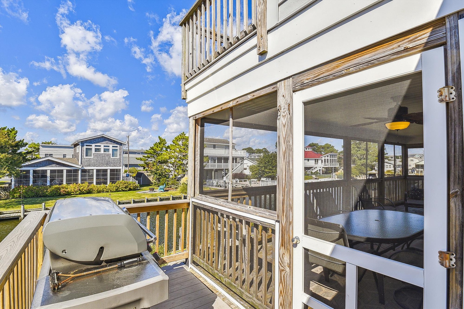 Step onto your private deck where neighborhood views and waterfront glimpses await. Enjoy morning coffee or evening gatherings in this inviting outdoor space, complete with a grill for al fresco dining.