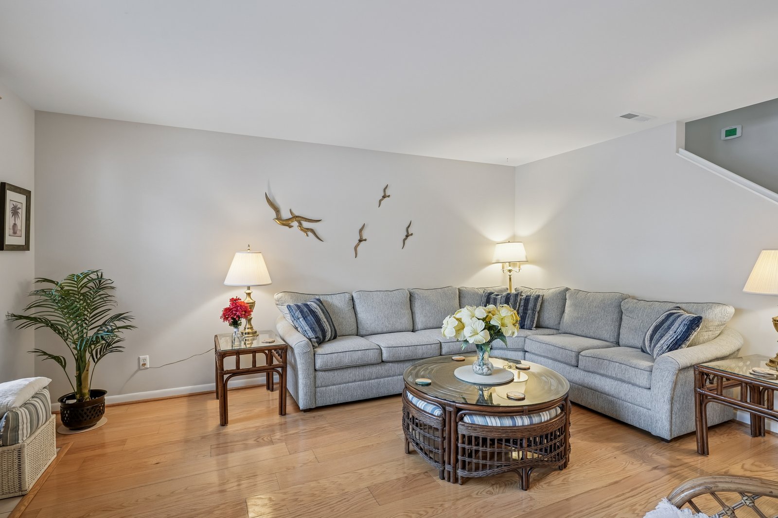 Unwind in your spacious living room, where coastal charm meets comfort with a plush sectional and warm lighting for perfect relaxation.