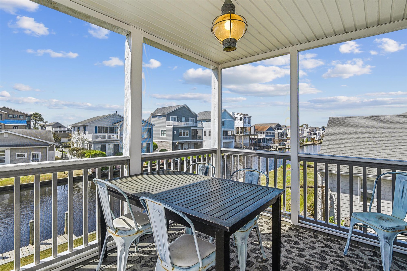 Waterfront neighborhood with multi-story homes and canal views. Property located in a developed residential community with boat access and coastal architecture.