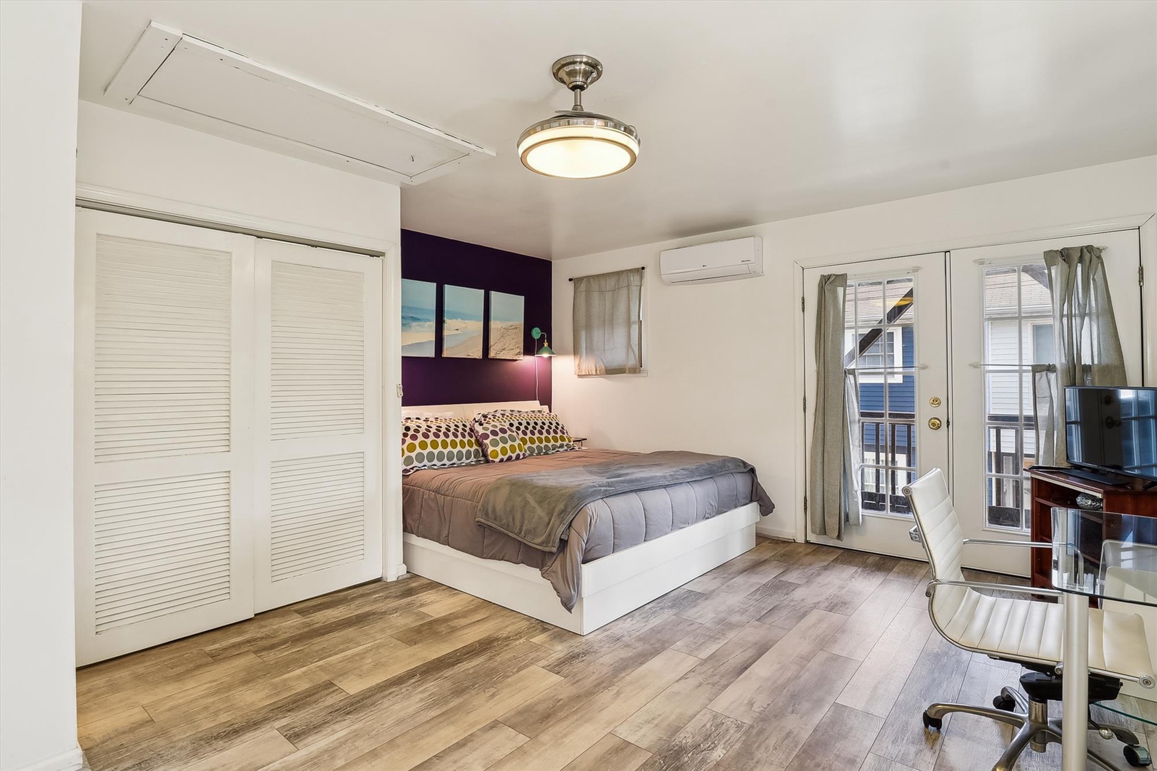 Your stylish bedroom invites restful nights with a plush queen bed, modern accents, climate control, and balcony access for fresh air.
