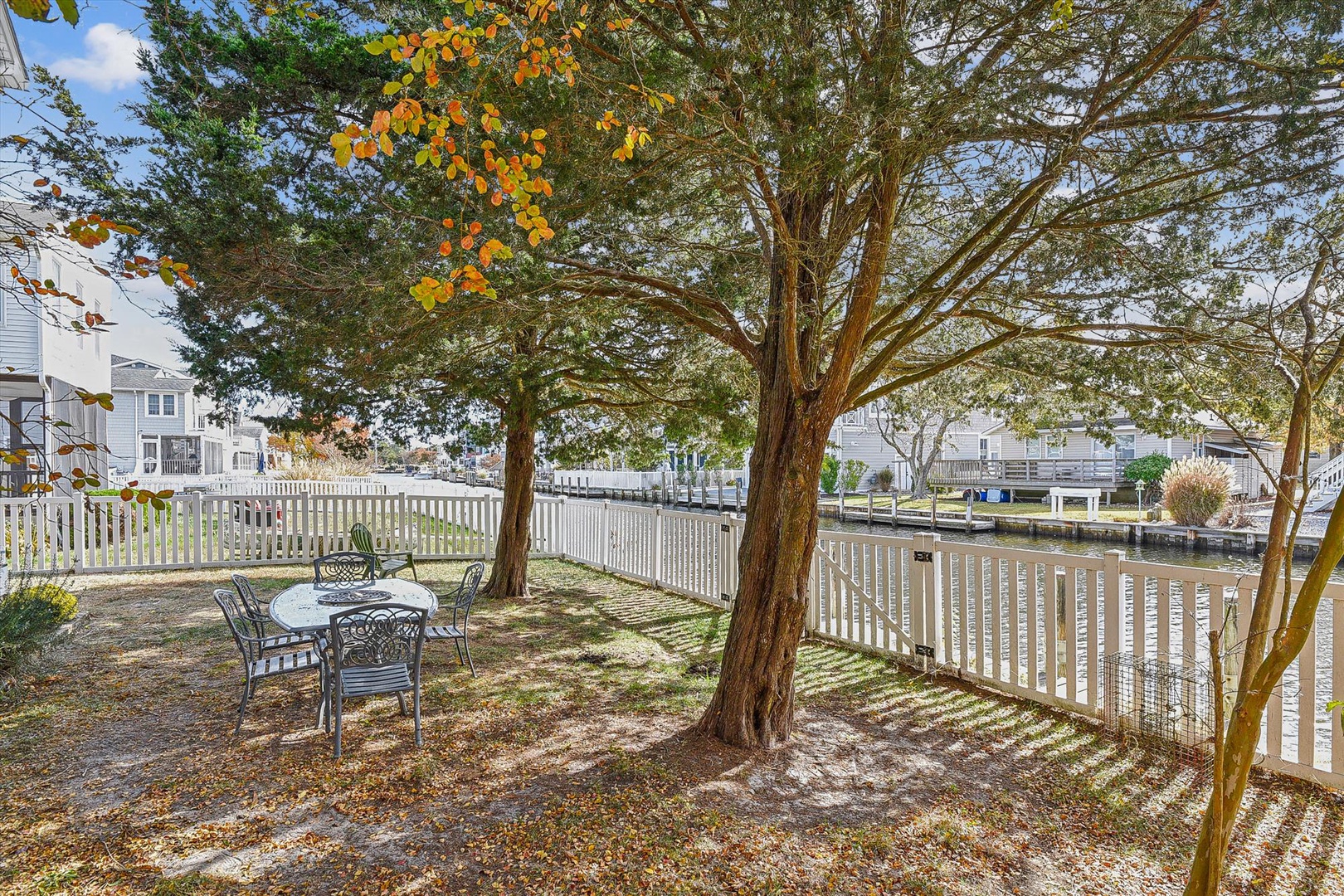 The property sits along a peaceful waterway in a quiet residential neighborhood, offering a serene backdrop for an autumn getaway.