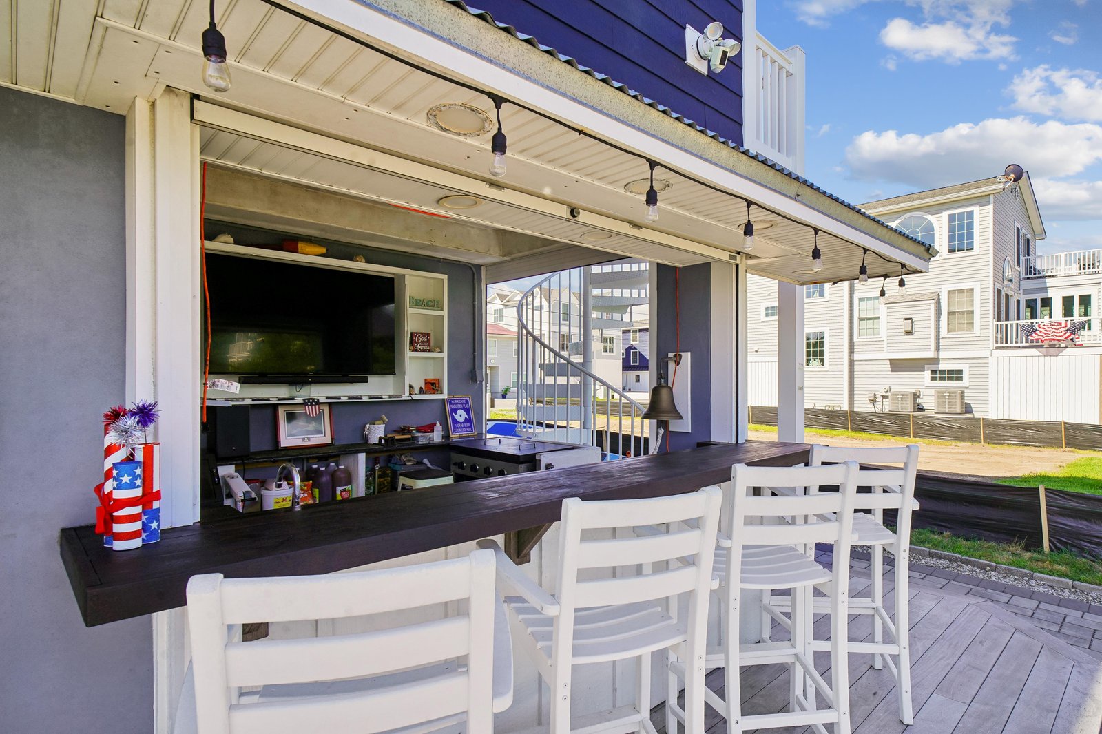 Your covered outdoor bar beckons with bar seating that opens to a spacious entertaining area—perfect for gathering with friends while enjoying refreshments and fresh air.
