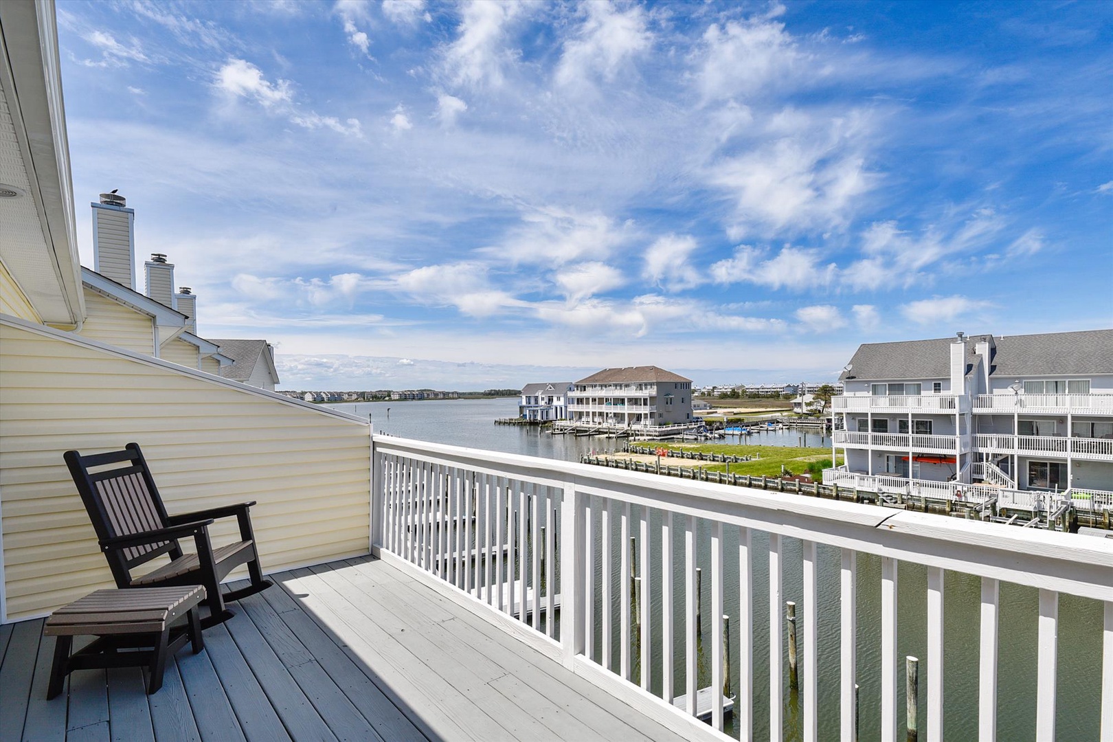 Settle into your private balcony and soak in sweeping waterfront views. The peaceful marina setting and distant shoreline create a serene backdrop for morning coffee or evening relaxation.
