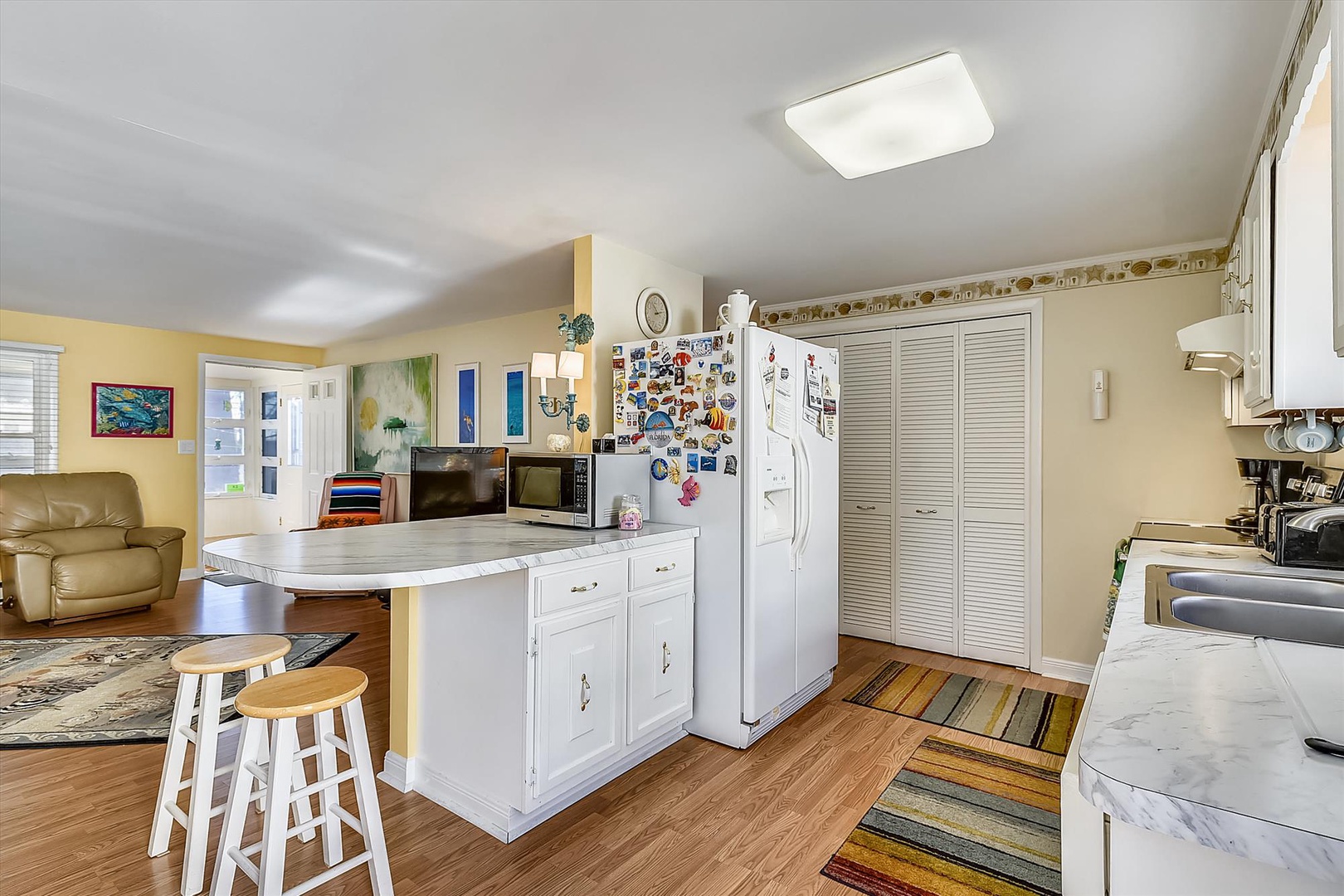Step into your fully equipped kitchen space with generous counter areas, modern appliances, and a welcoming island perfect for preparing meals or enjoying casual conversations over morning coffee.