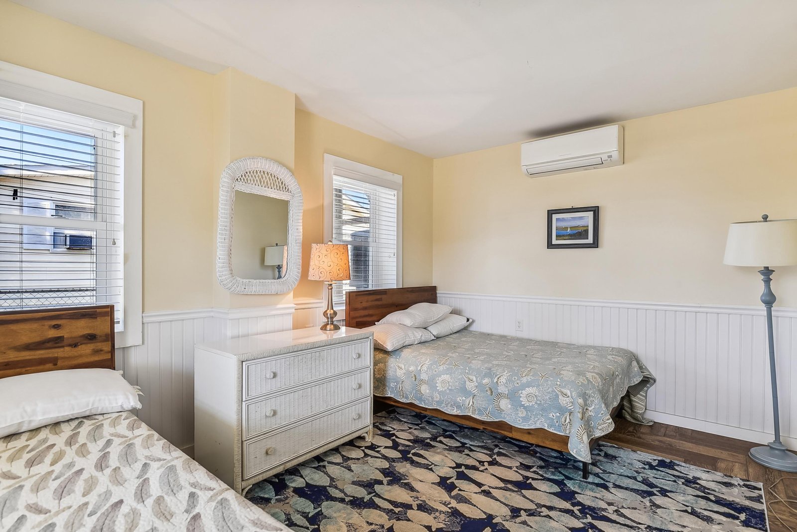 Drift off in your cozy twin-bedded retreat, where soft yellow walls and nautical charm blend with modern comfort for a restful night's sleep.