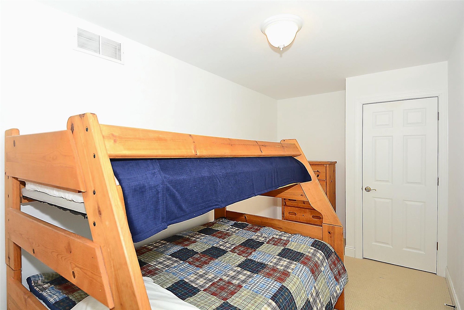 Your kids will love this cozy bunk room with rustic wood beds, perfect for making vacation memories together in a space that feels like a mountain retreat.